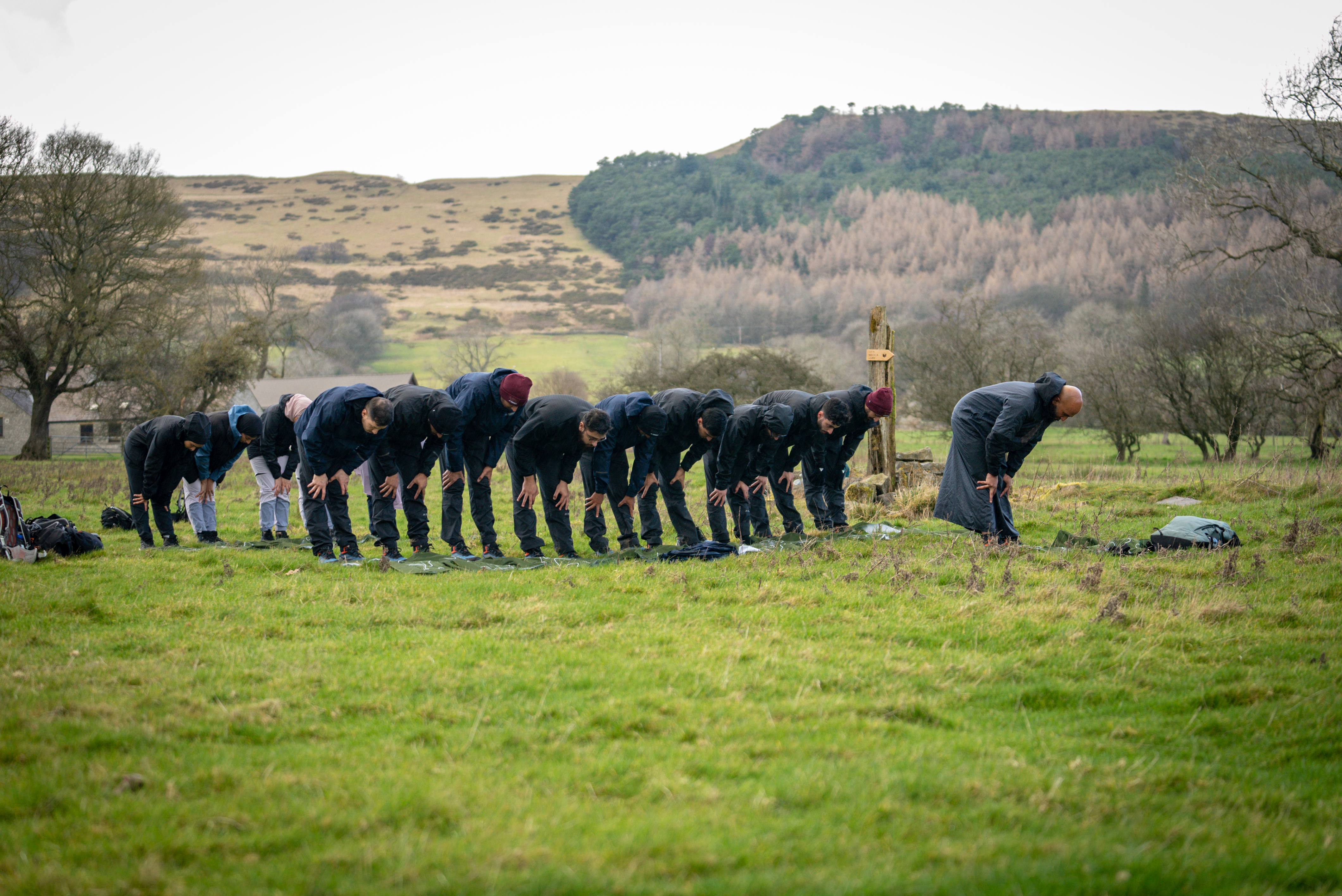 Group standing together and bowing down