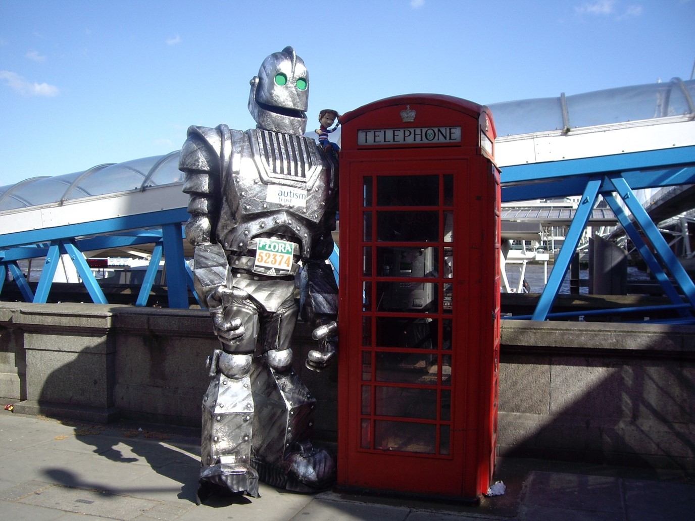 Man in tin suit standing next to a phone booth
