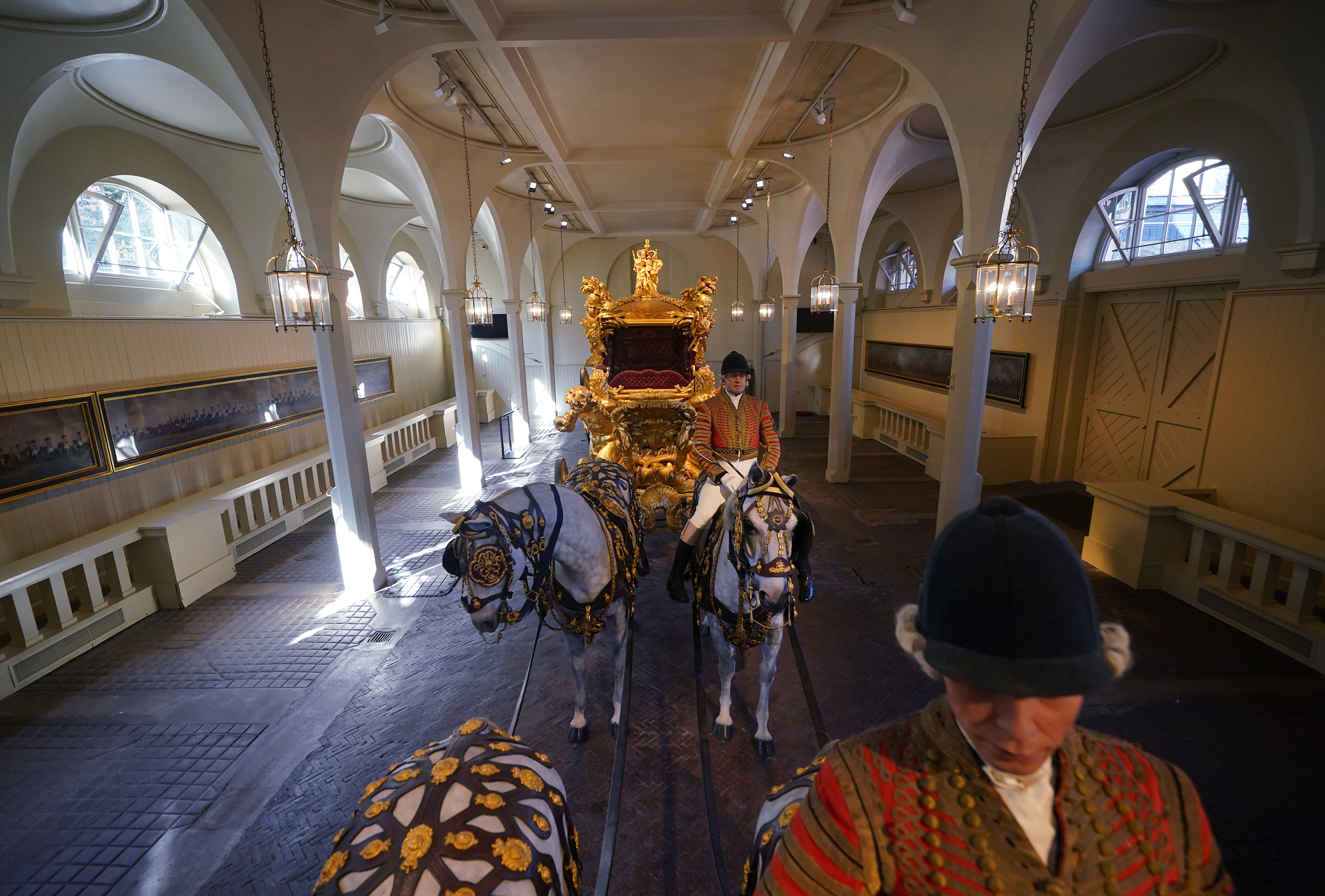 The Gold State Coach with models of horses in the Royal Mews