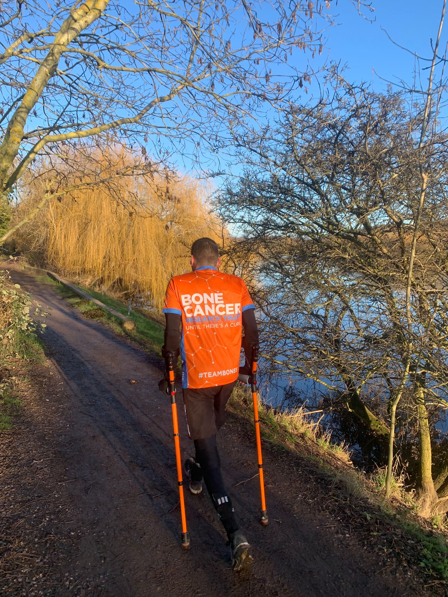 Man walking using crutches 