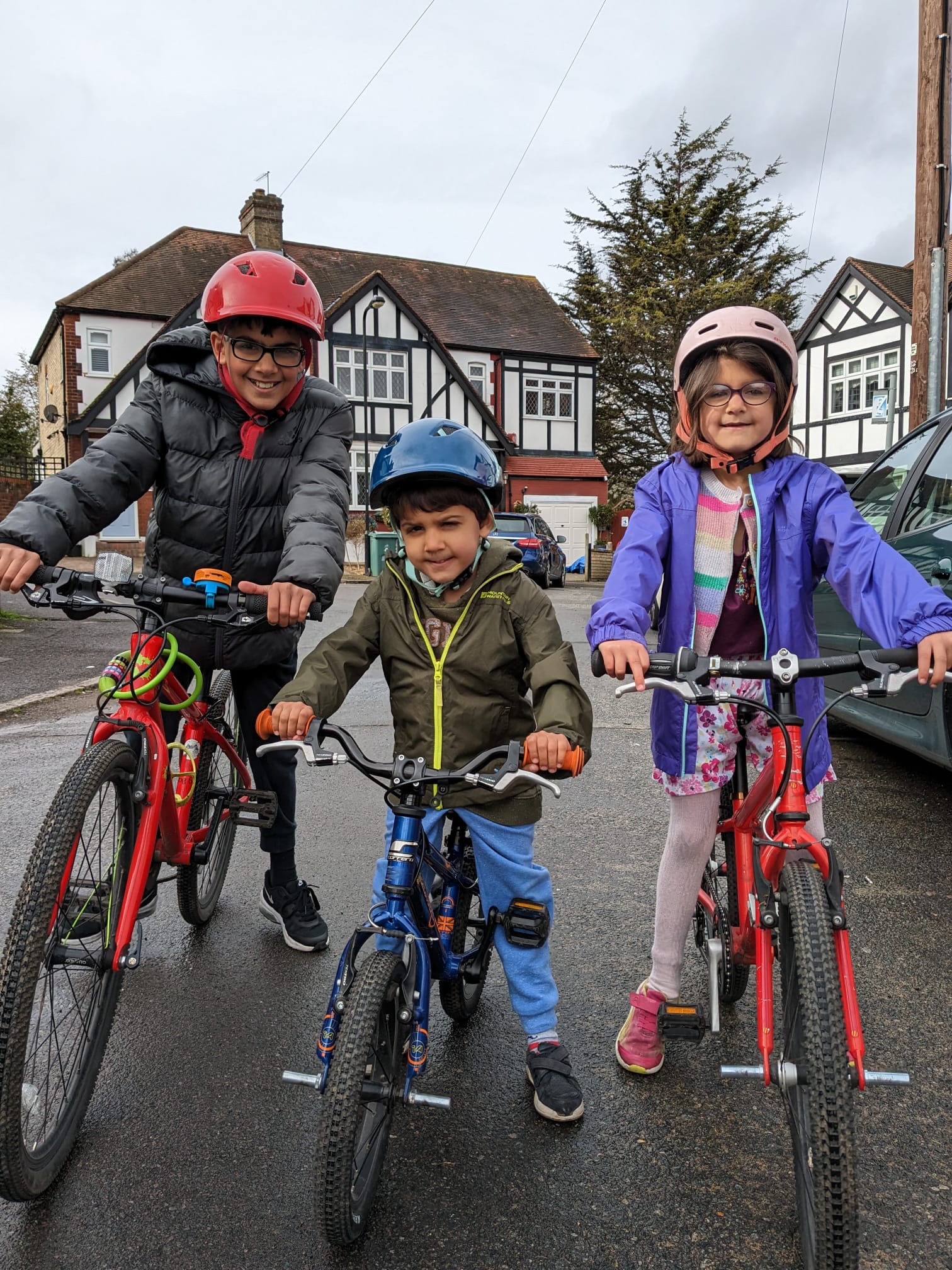 Children standing behind bikes 