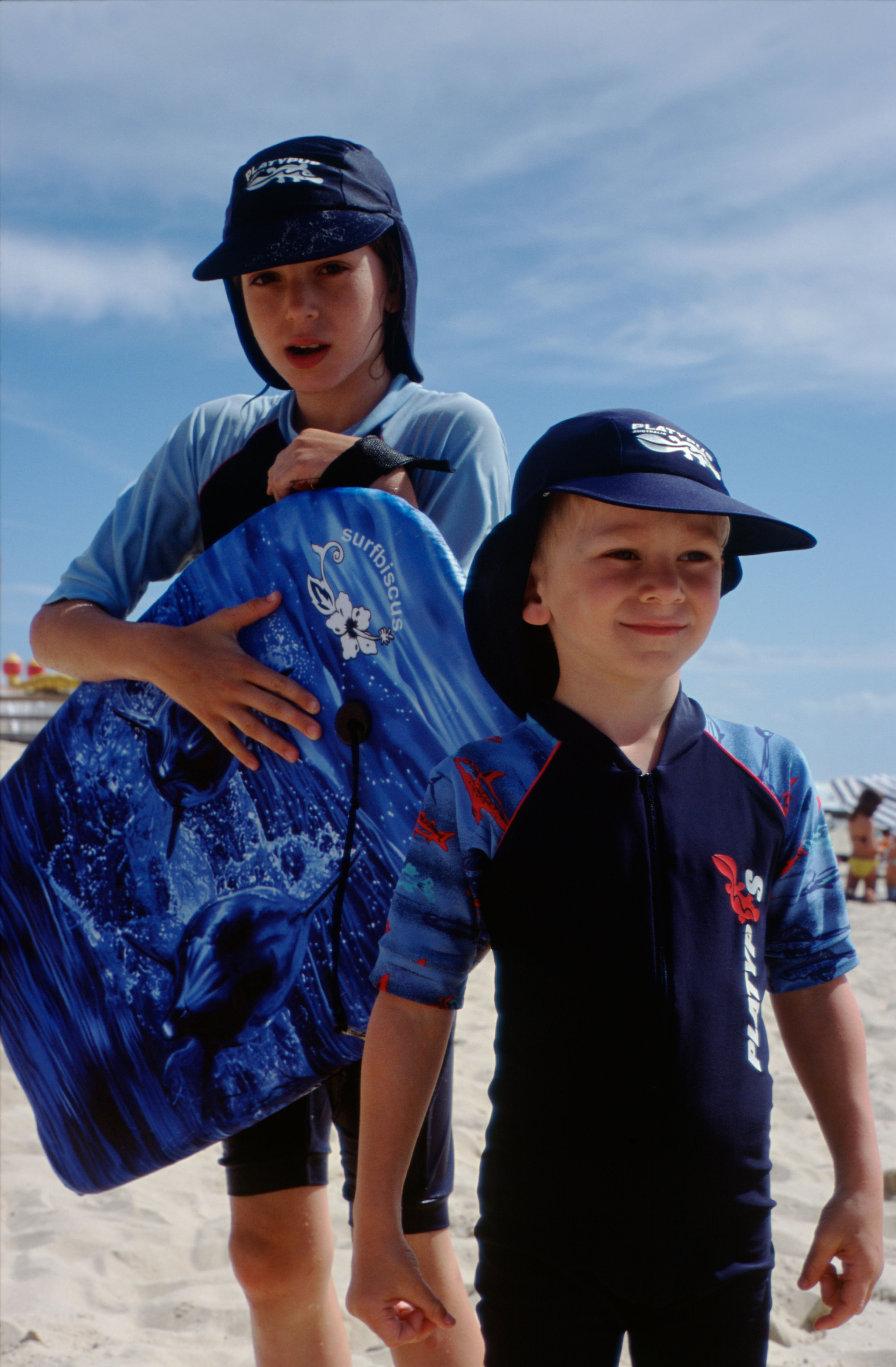 children wearing UV protection clothing on beach