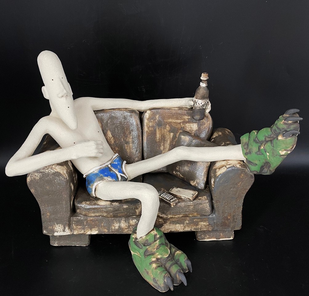 Sculpture of person relaxing on a chair 