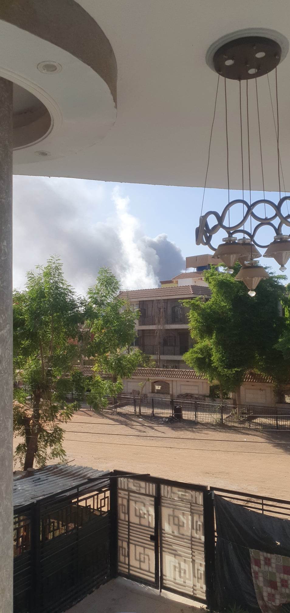 Plumes of black smoke rising above buildings in Khartoum, Sudan