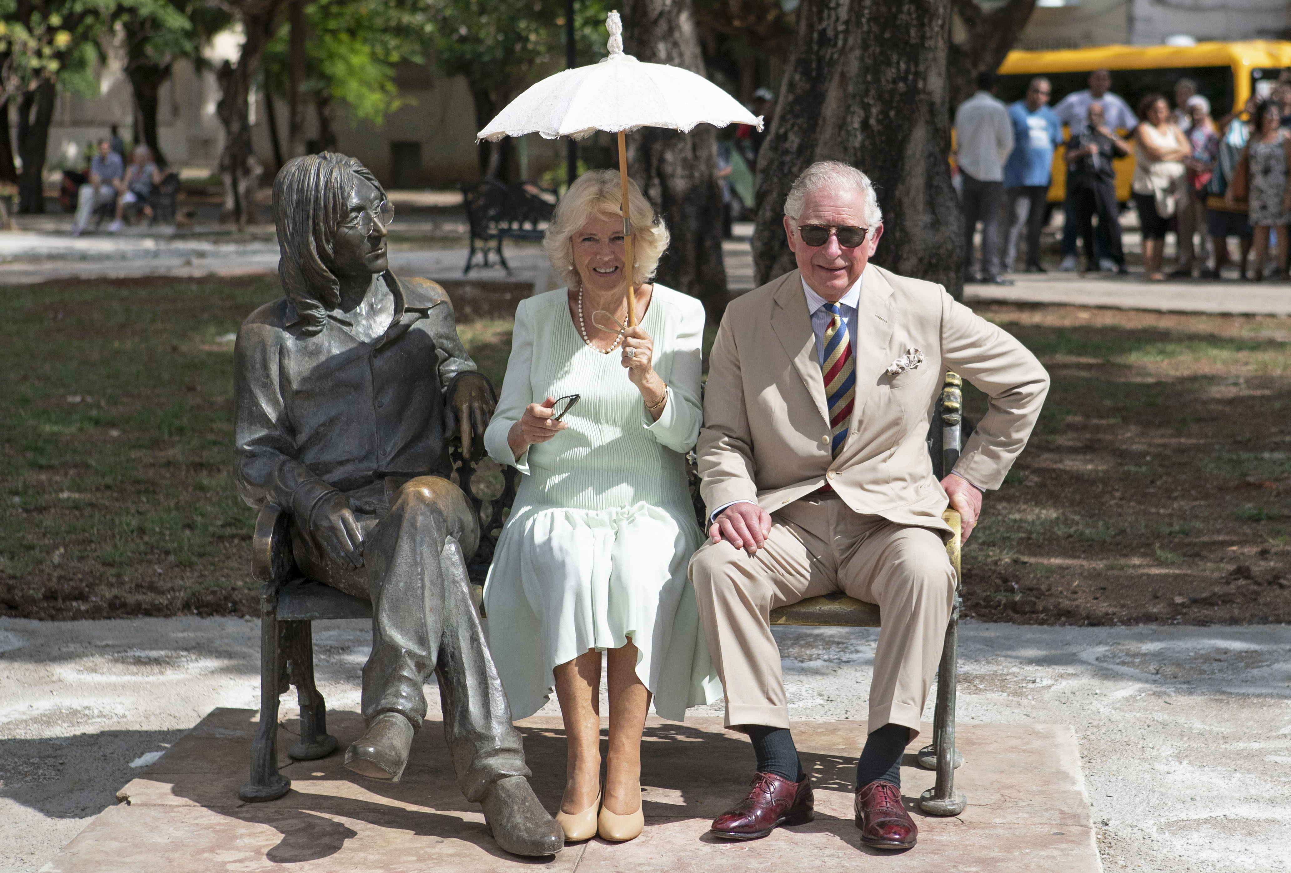 Charles and the then-Duchess of Cornwall sitting on the John Lennon memorial bench in Havana, Cuba