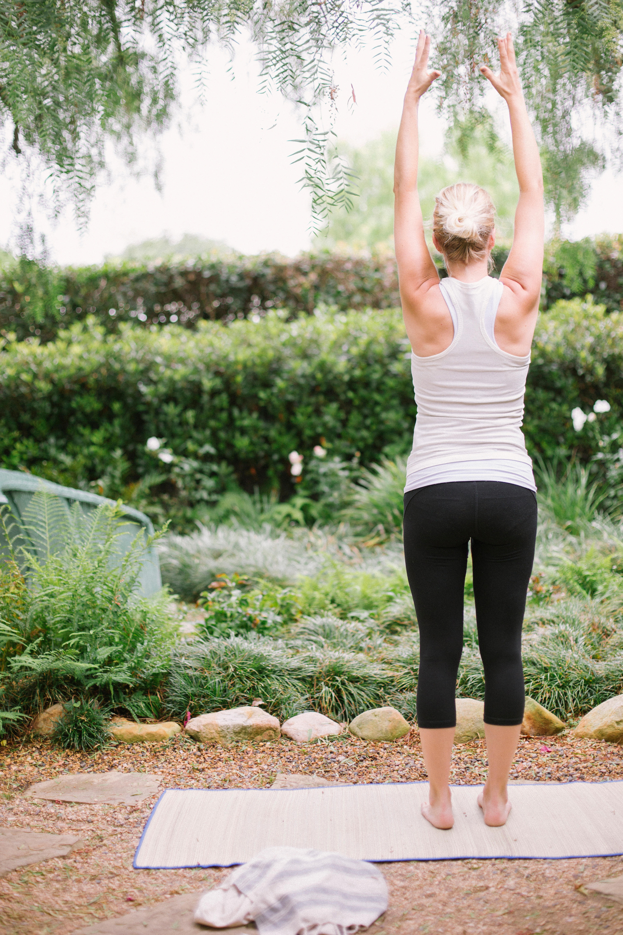 Woman doing yoga in a garden (Alamy/PA)