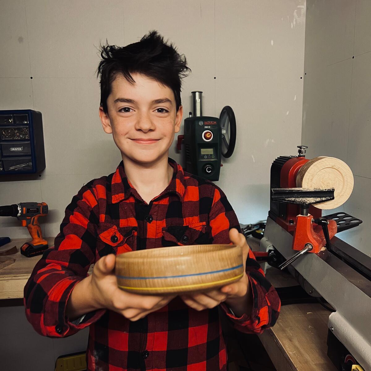 Boy holds handmade bowl