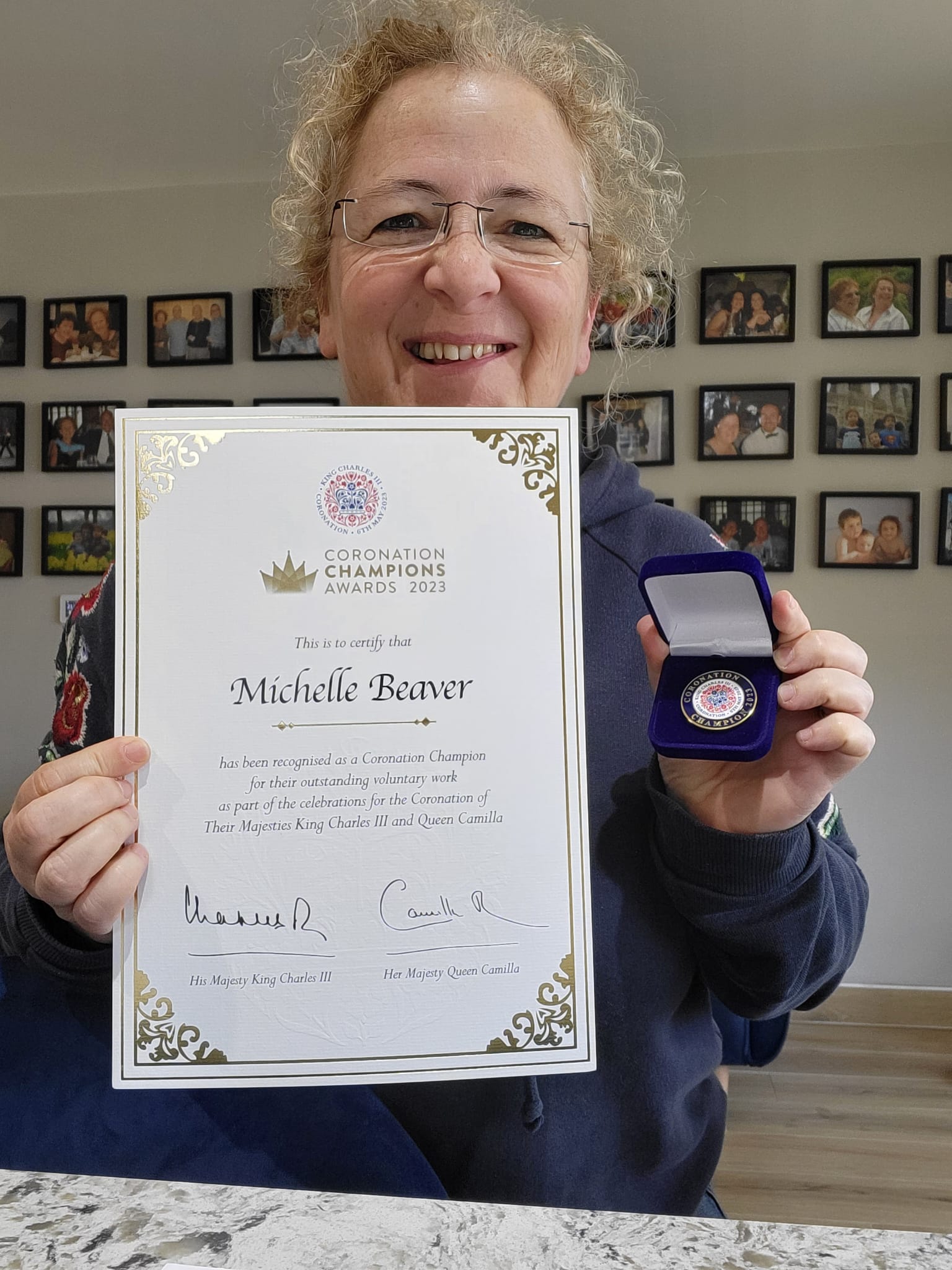 Woman holding pin and certificate 
