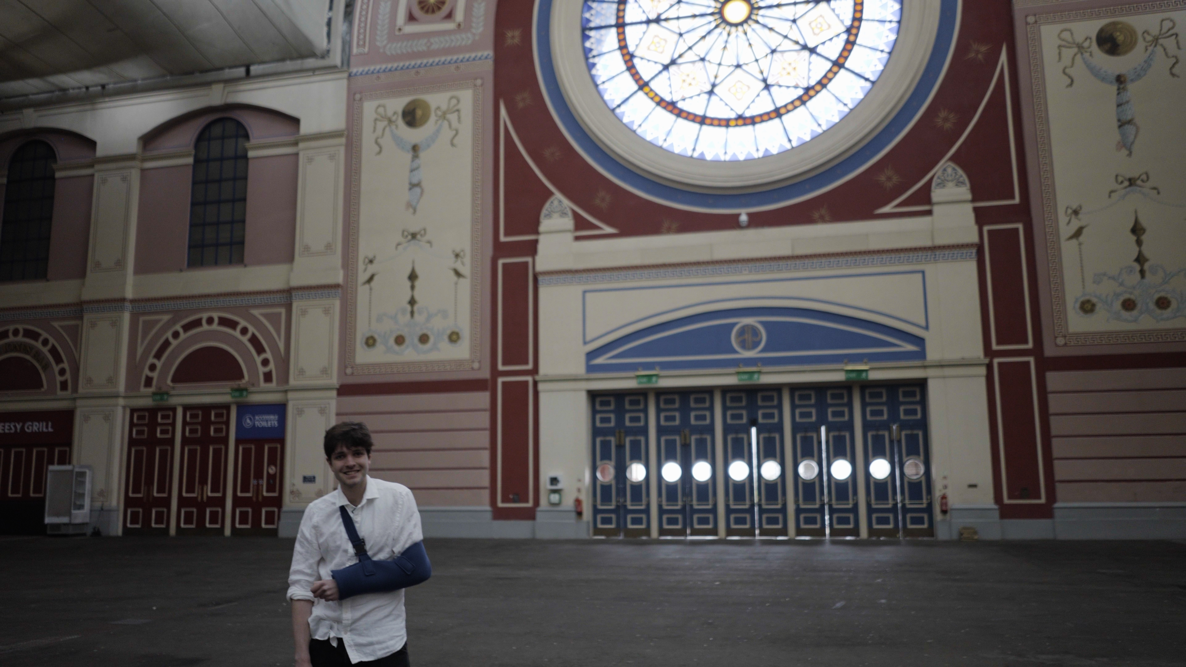 History PhD student Patrick Hegarty Morrish explores the hidden history of the Great Hall at Alexandra Palace in London. (Historic England/ PA)