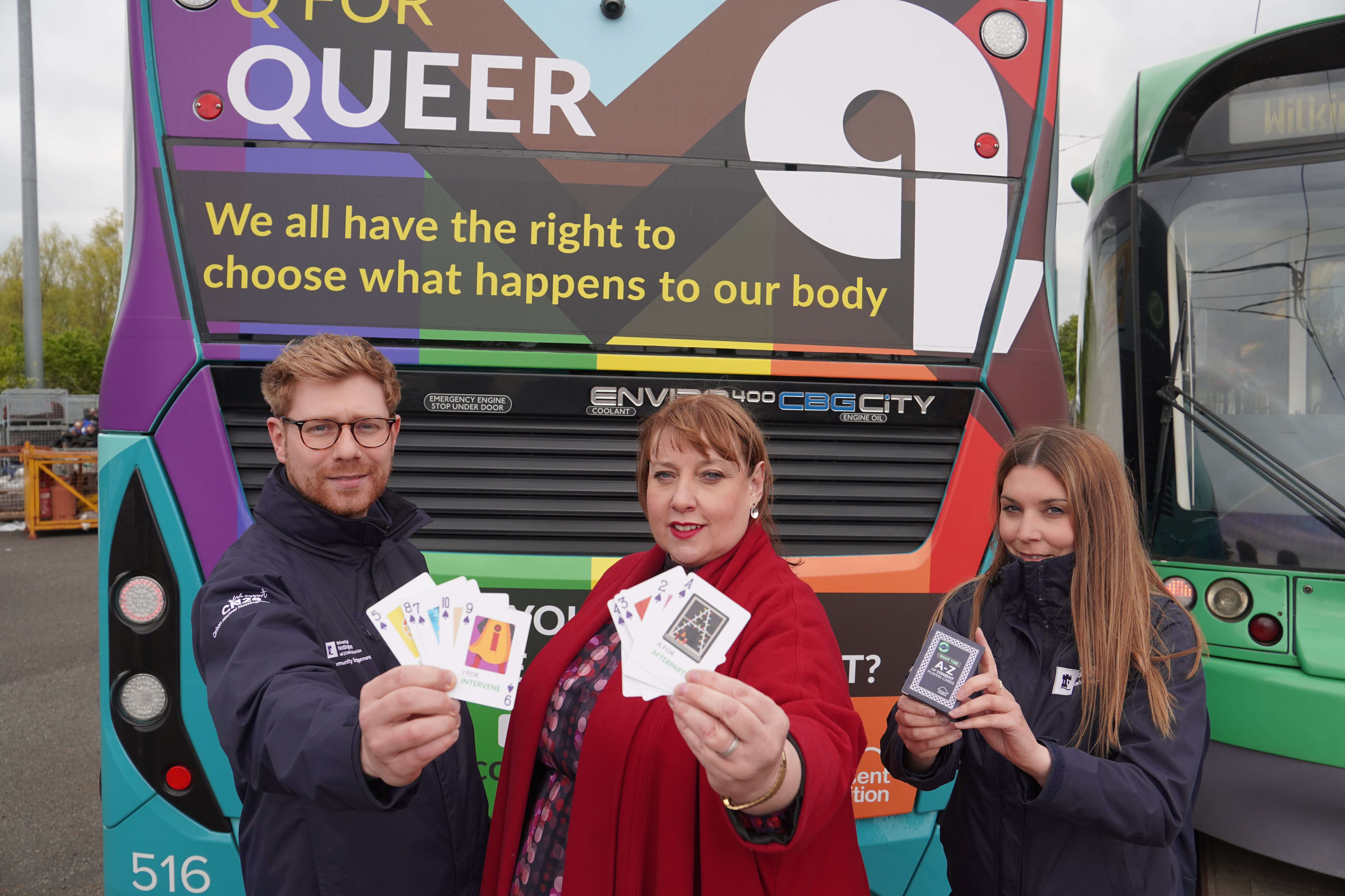 Caroline Henry (centre), behind one of the wrapped buses, said that the scheme aims to "provoke big conversations". (Office of the Nottinghamshire Police and Crime Commissioner/PA)