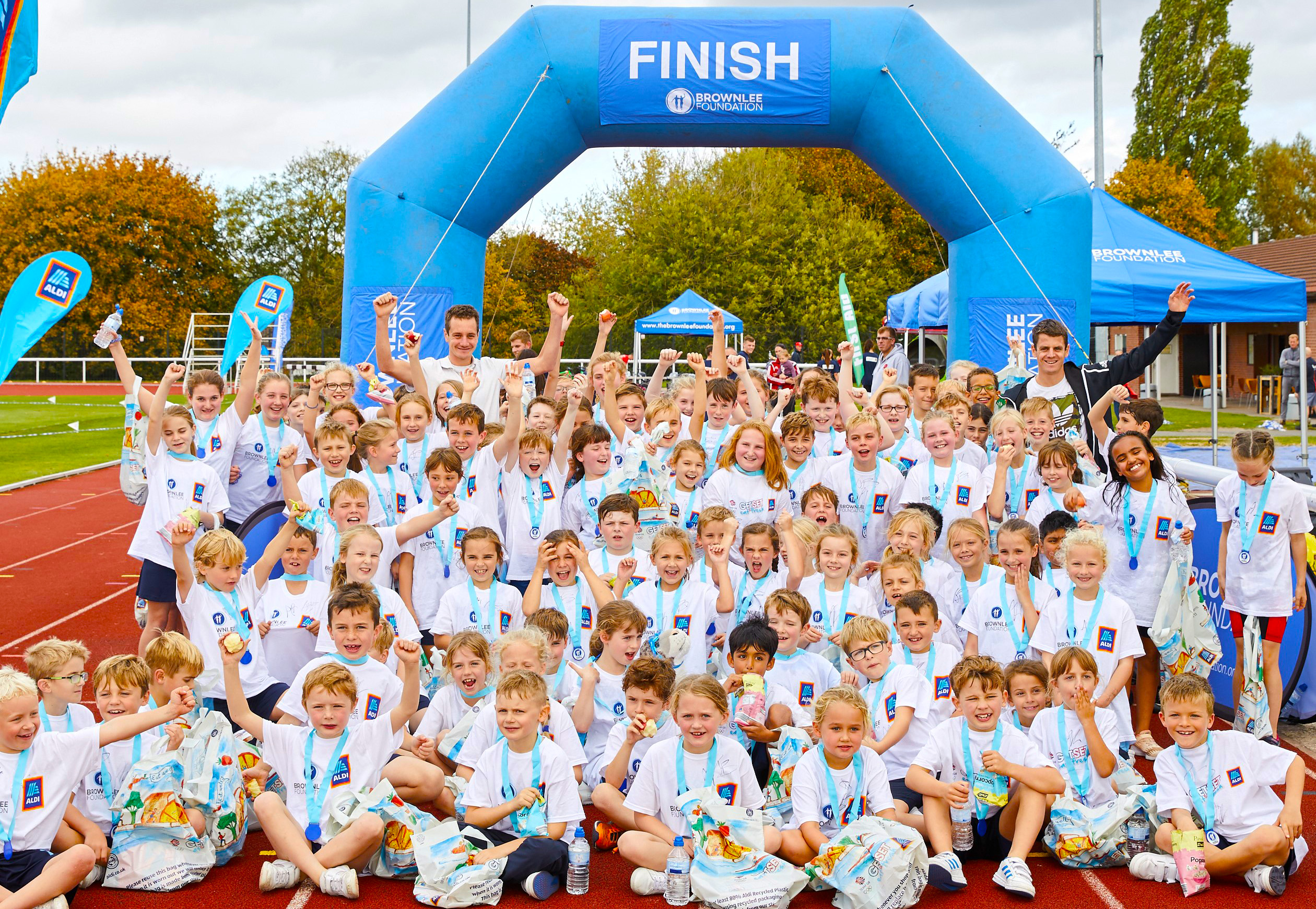 Jonny and Alistair Brownlee with children at a Brownlee Foundation event