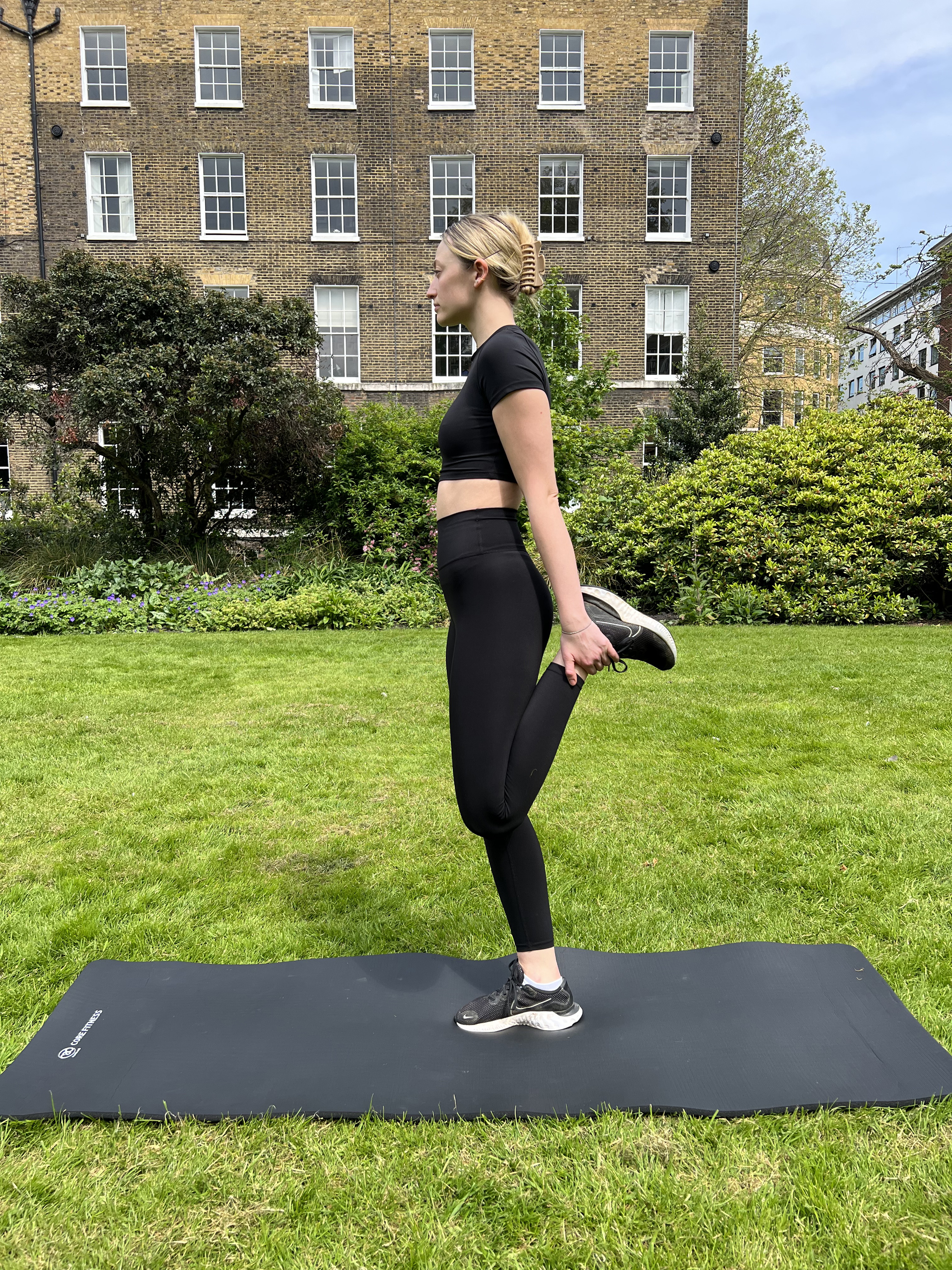 A woman in a garden doing a quadriceps stretch (Until/PA)