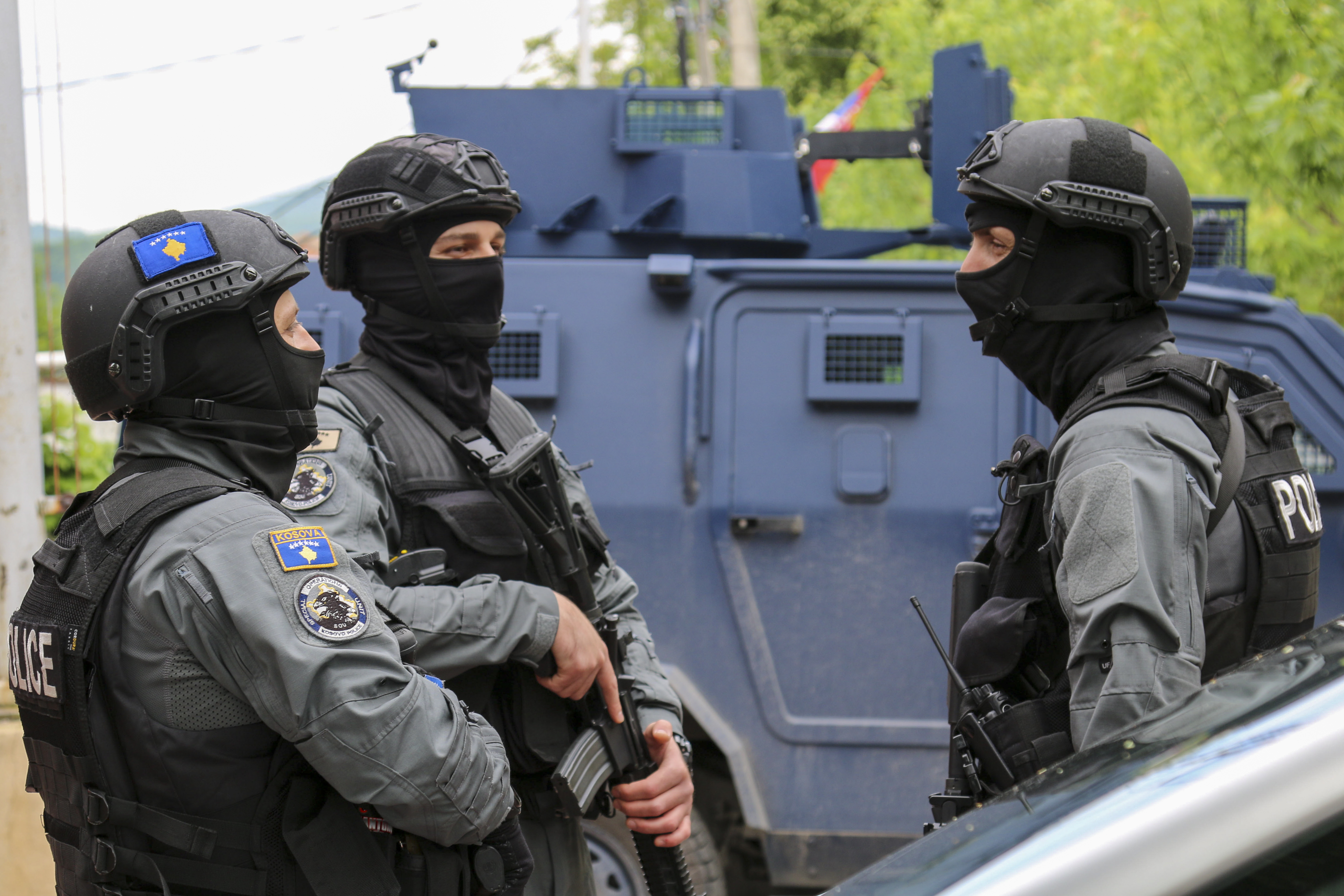 Kosovo police officers guard a municipal building