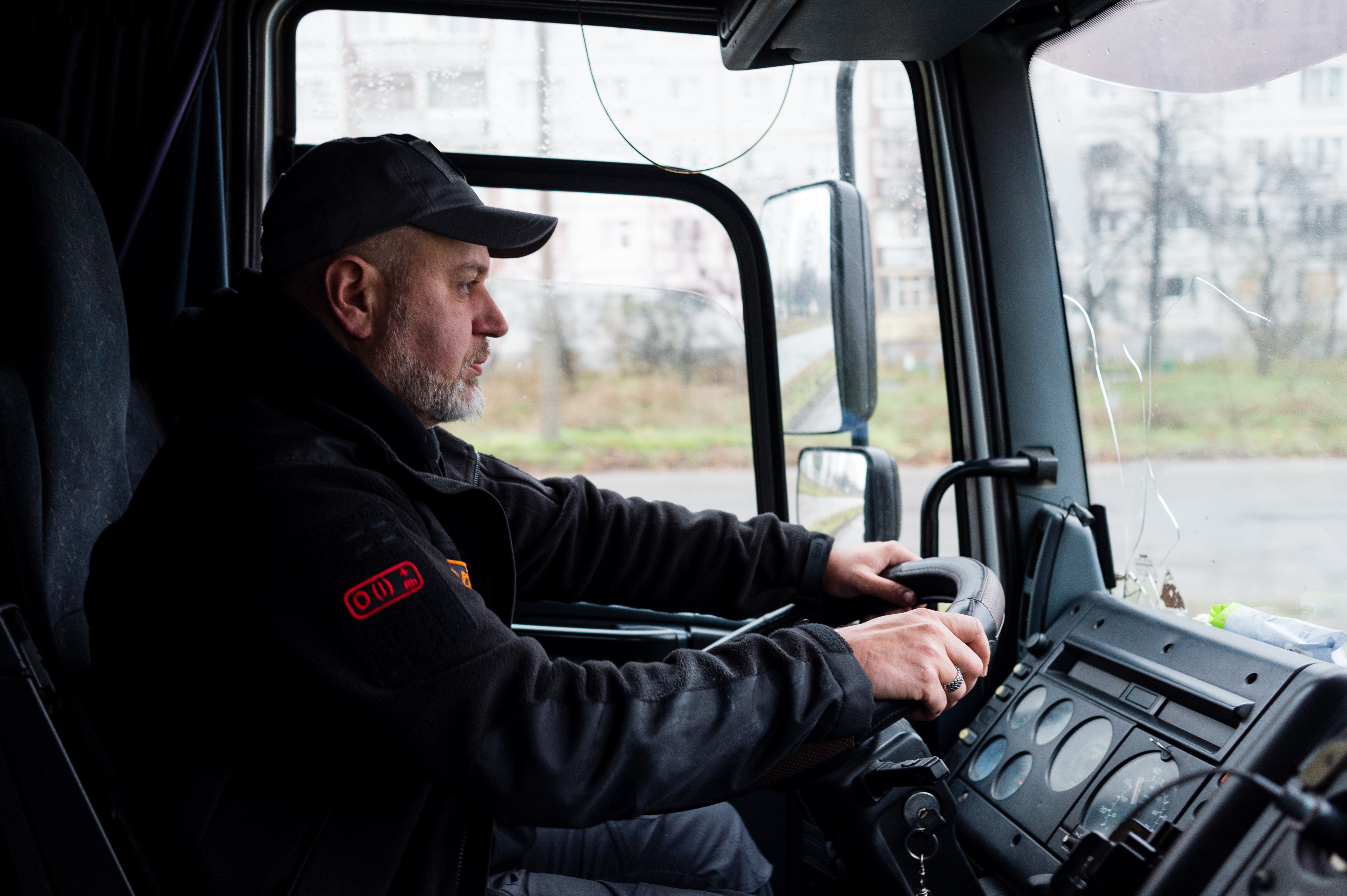 Father Vitaliy Novak drives a loaded with blankets, firewood and generators, ready for distributing to residents of a destroyed village outside Kharkiv