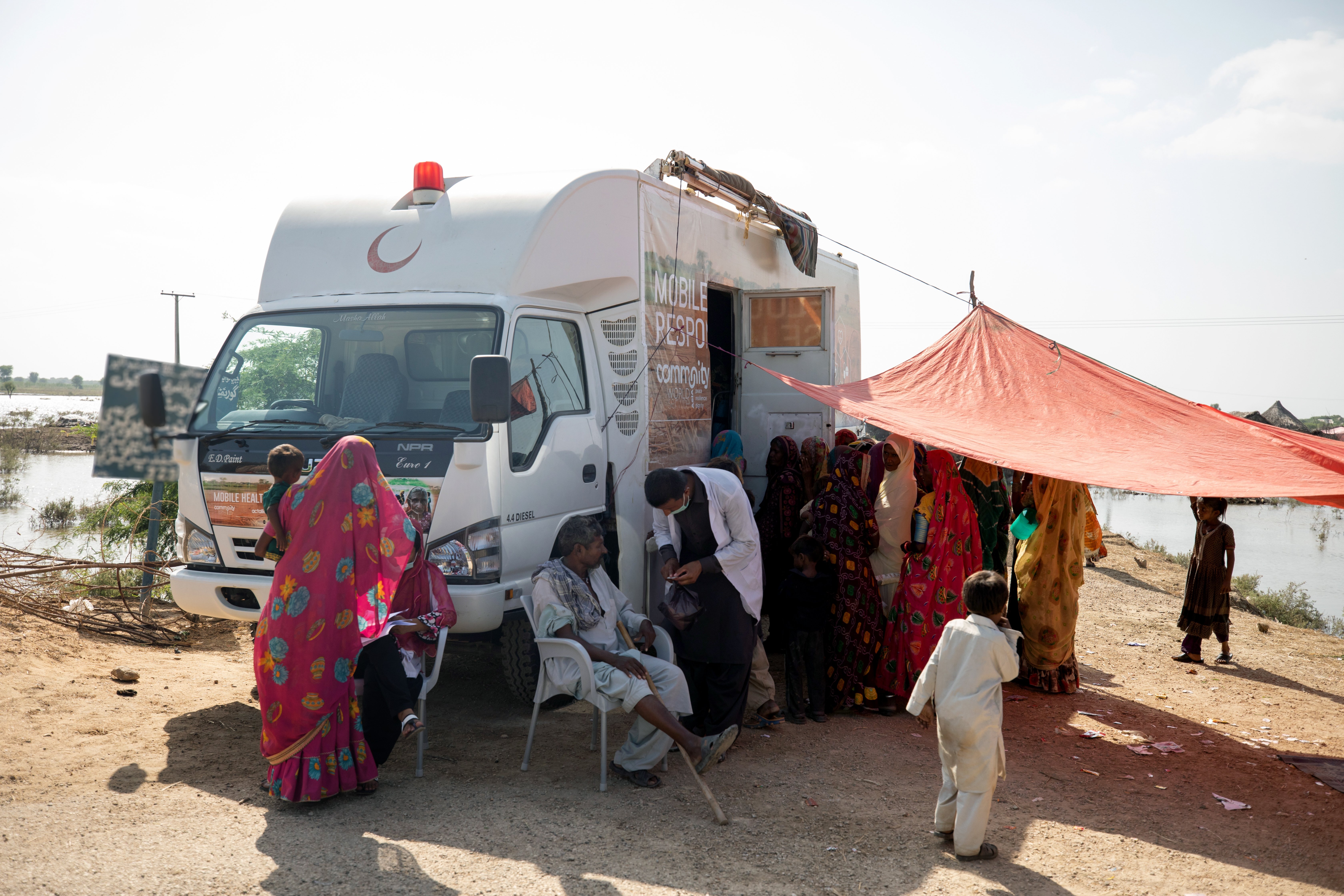 Flood survivors receive medical aid at a mobile clinic set up for flood affected families by CAFOD in Sindh, Pakistan