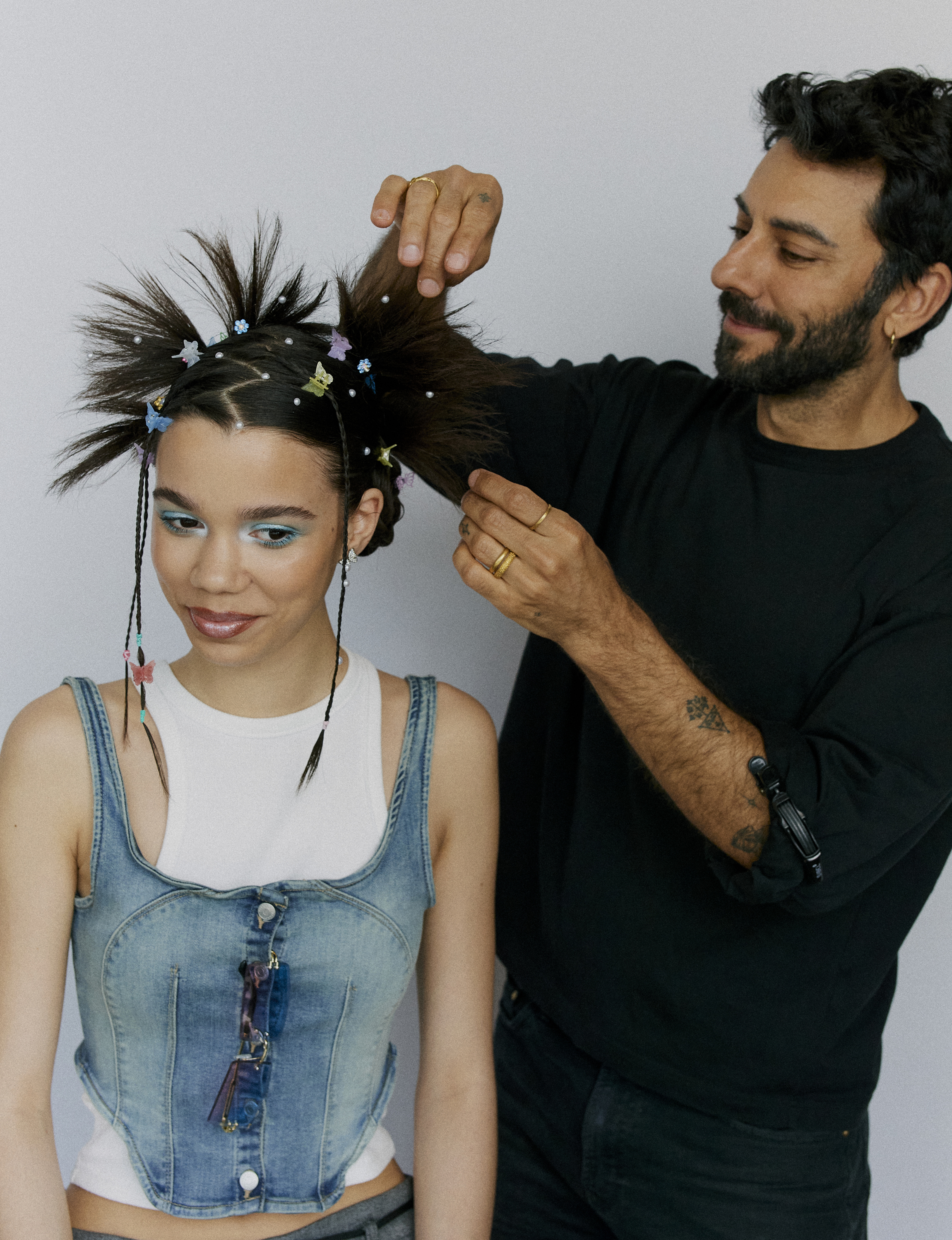 Peter Lux putting the final touches on a Noughties-inspired hairstyle