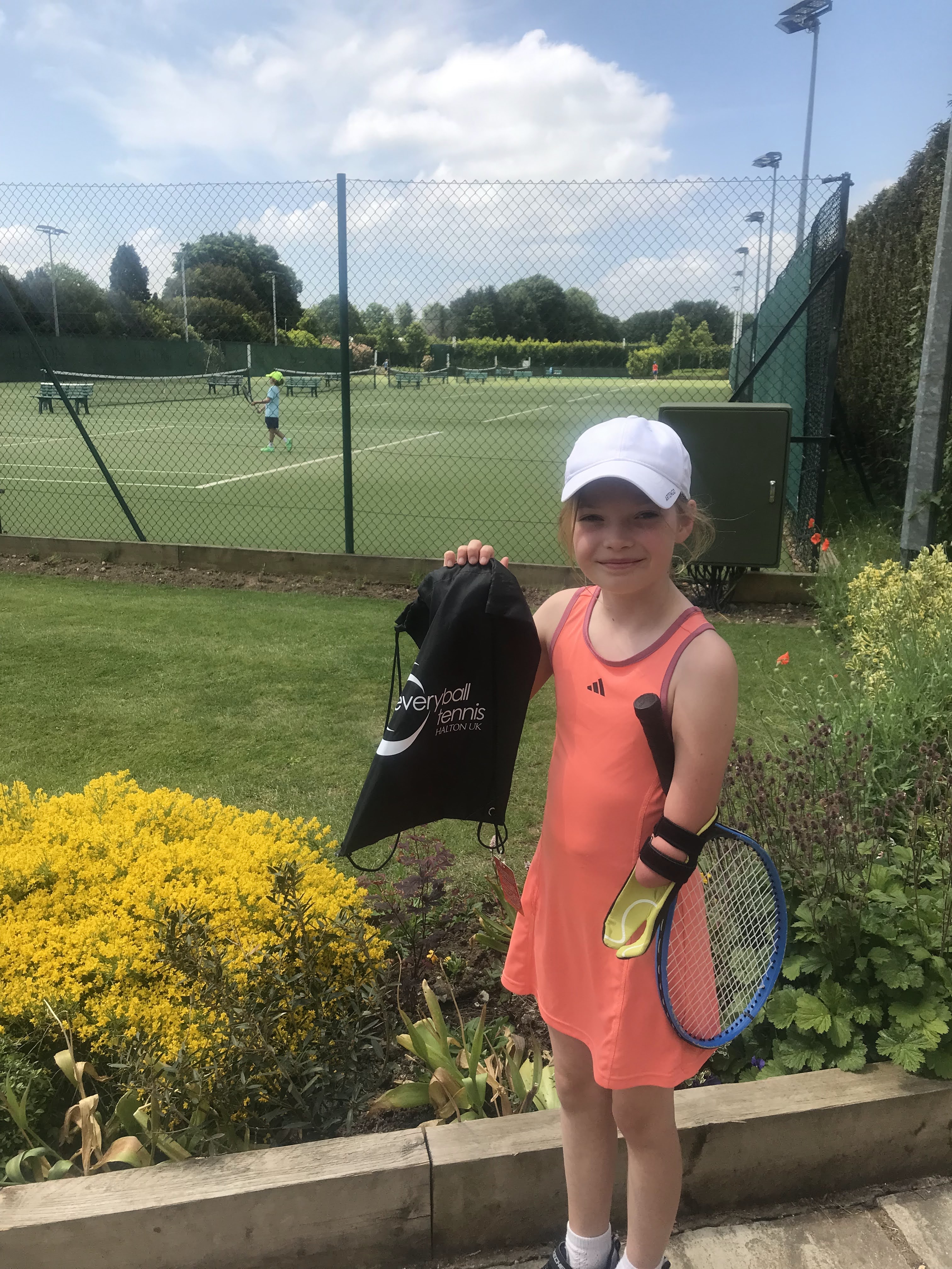 Joanie Melady holding a tennis racket after playing her first tournament
