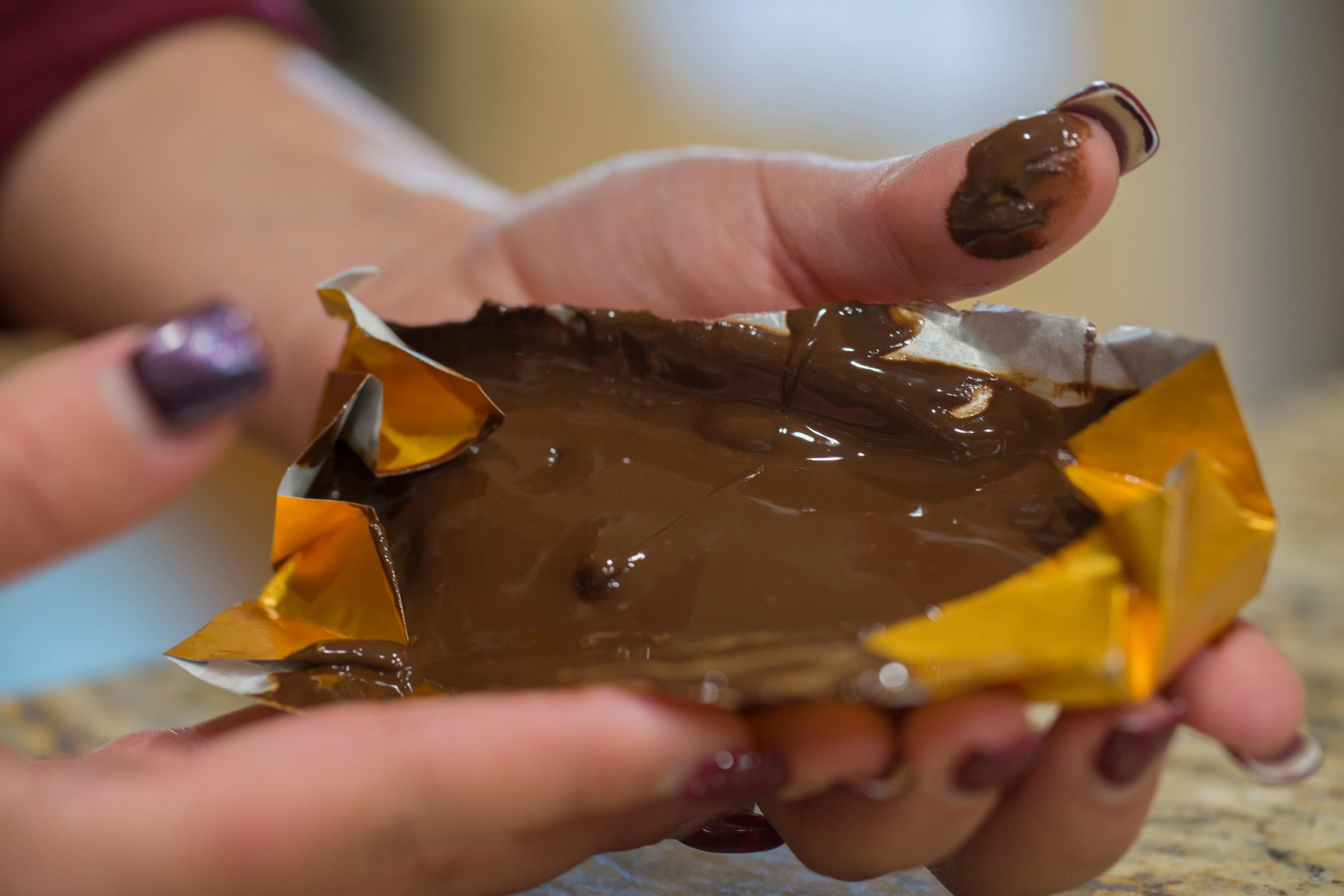 Woman unwrapping melted chocolate bar