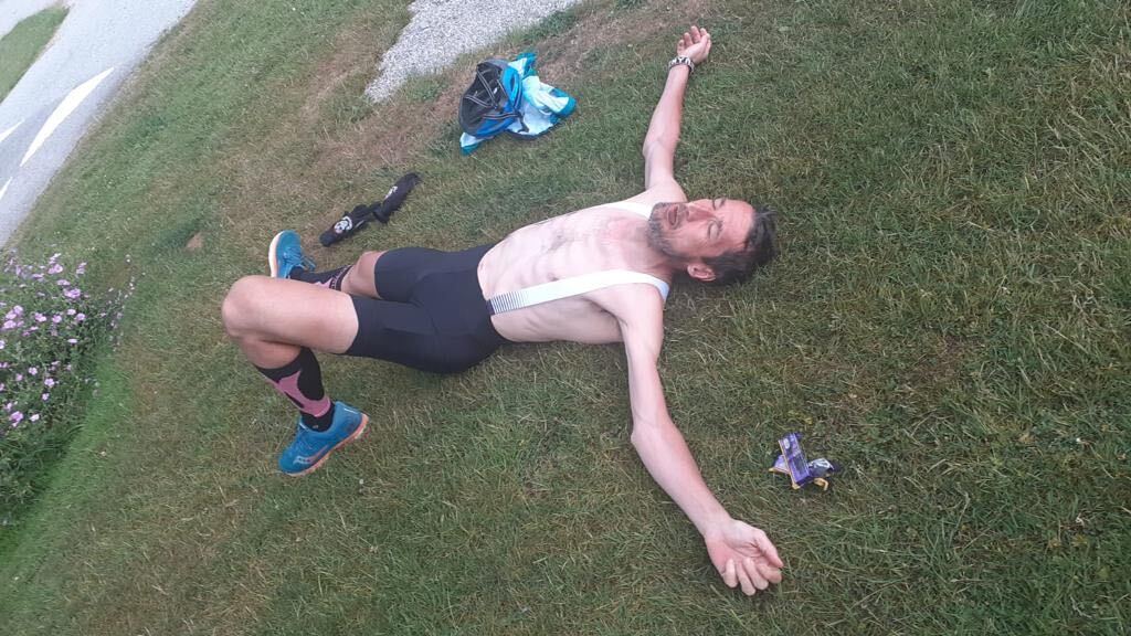 Rob Walker lying on the ground after travelling 85 miles in one day