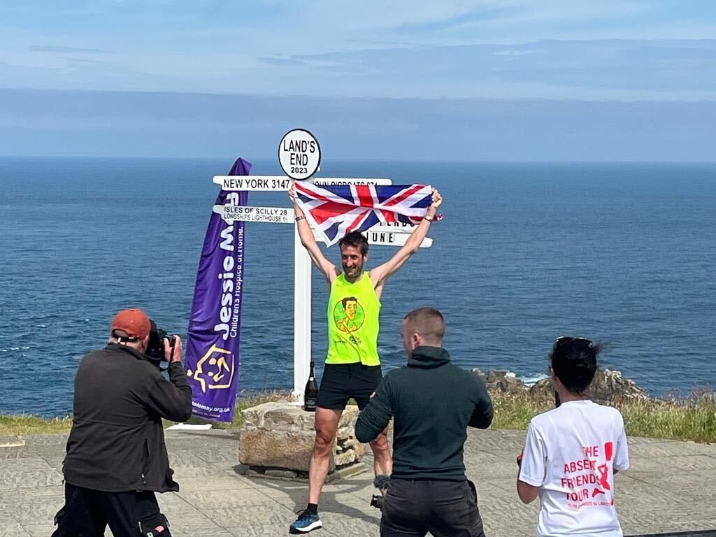 Rob Walker holding the Union flag in Land's End