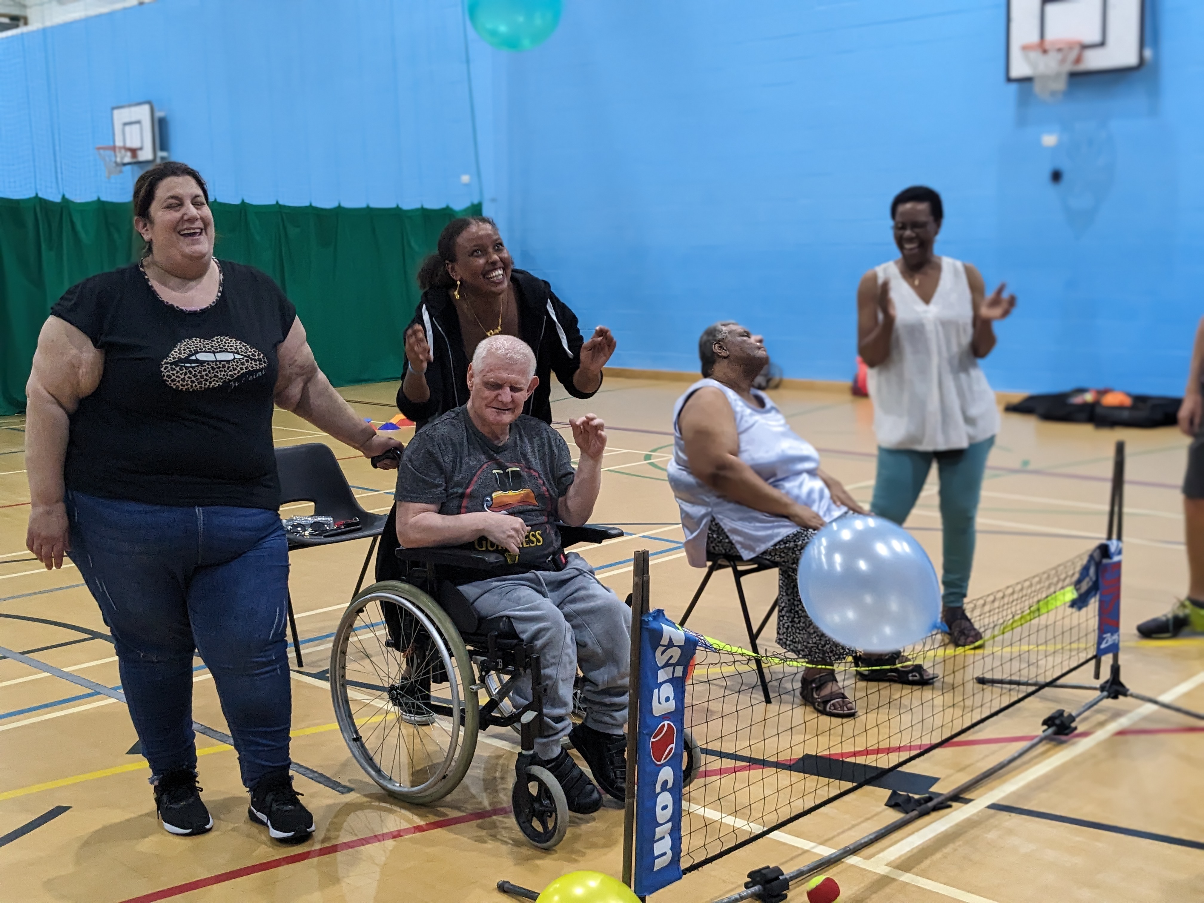 Players at a sensory tennis session in Barnet play with a balloon 
