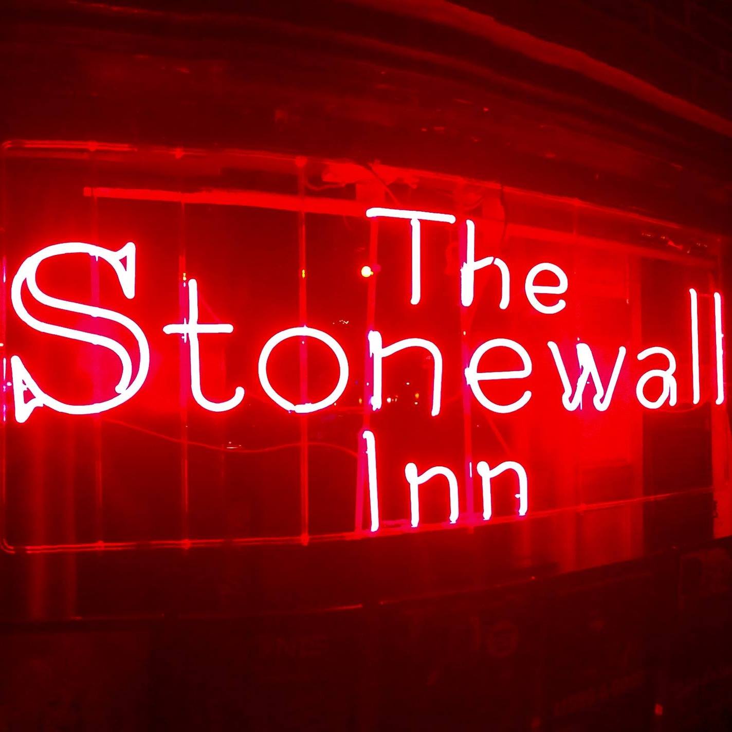 A red neon sign reading 'The Stonewall Inn'