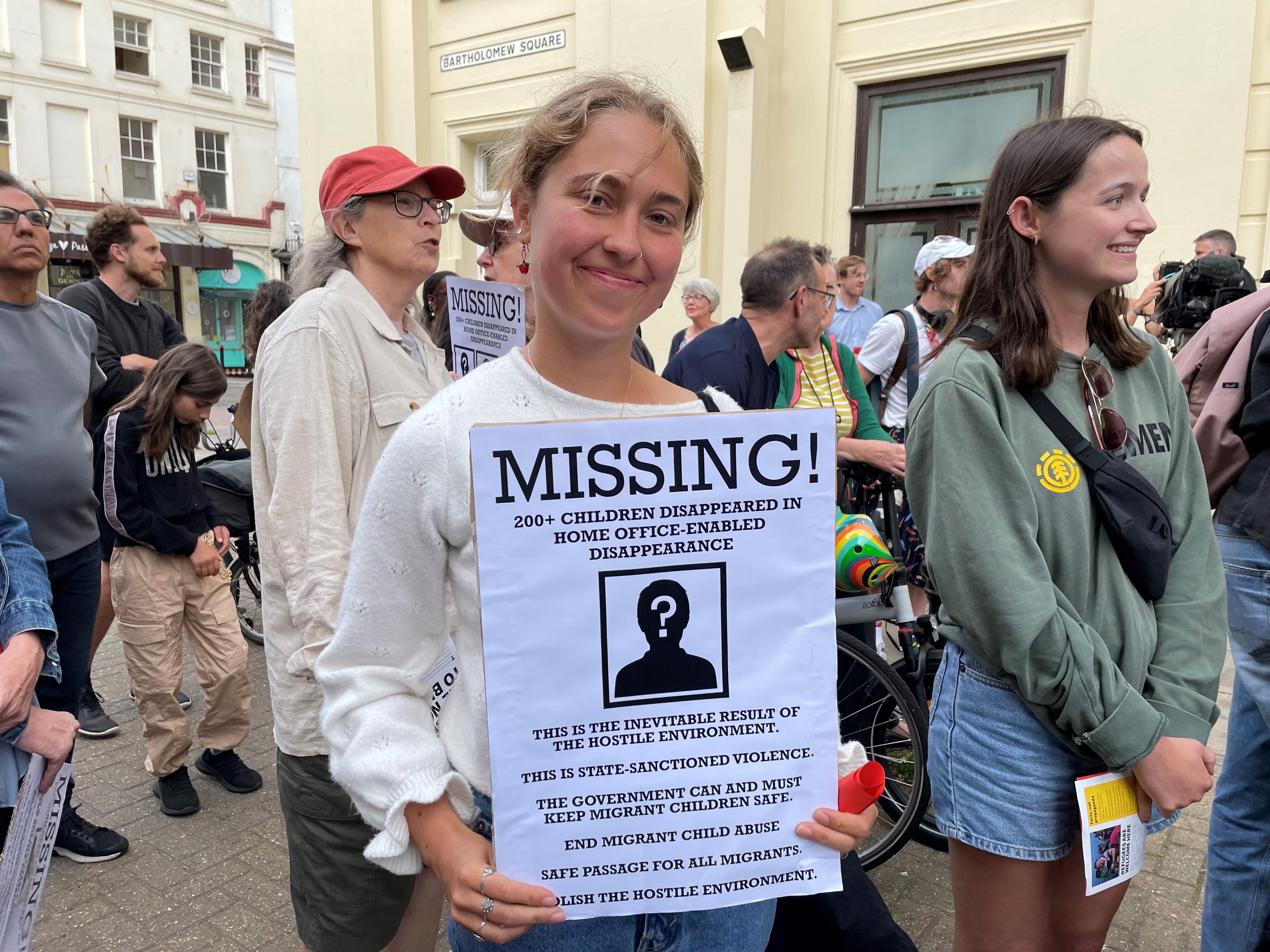 A protester holds a sign opposing Home Office plans to reopen the Hove hotel where children went missing