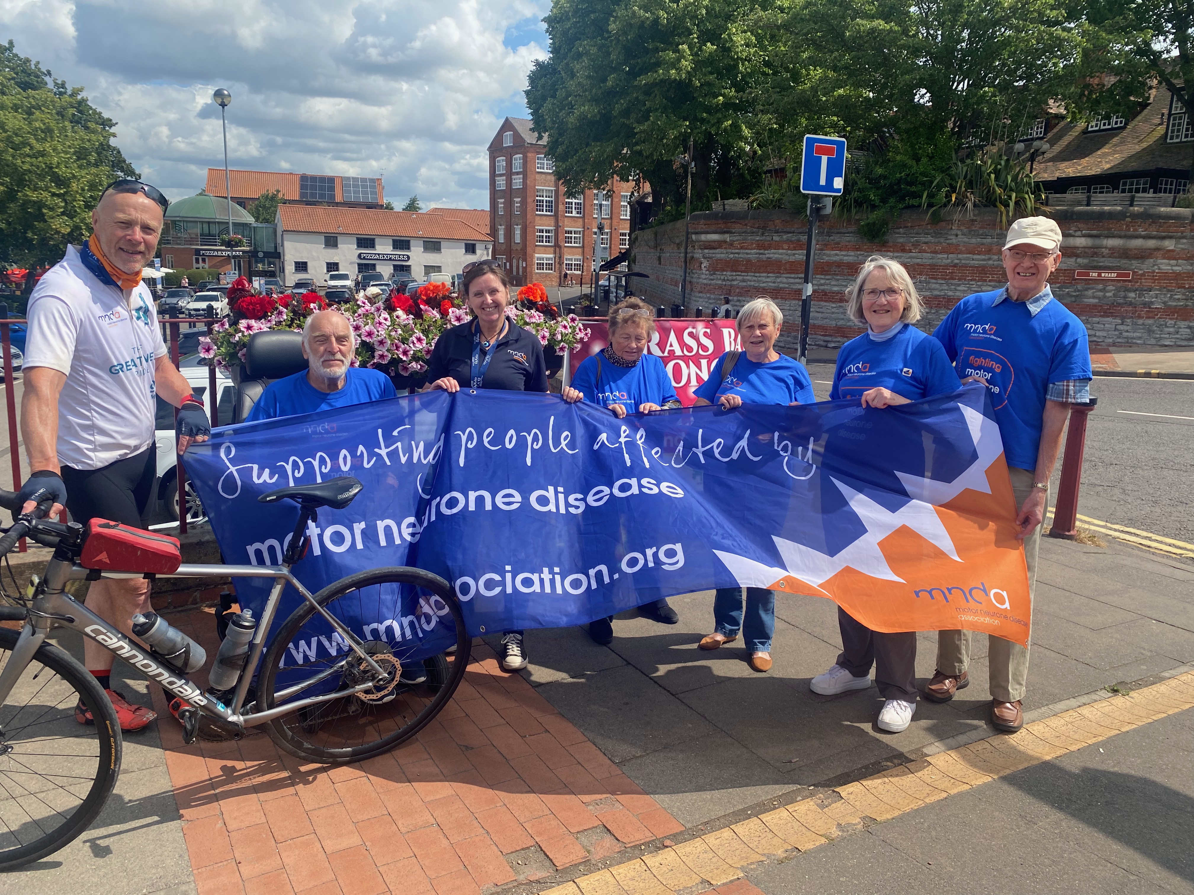 Pete Hawkins standing with the Nottinghamshire branch of the MND Association in Newark