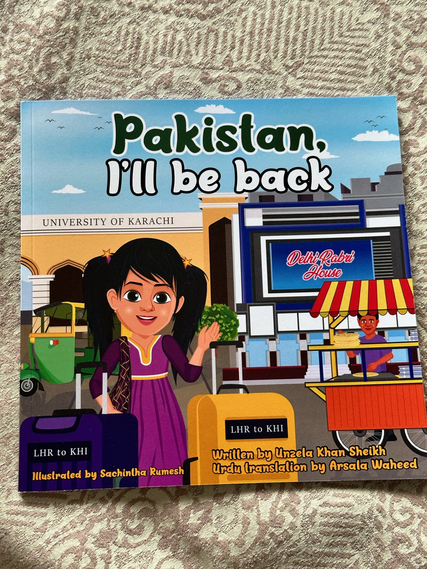The front cover of the book with a drawing of a young girl in Pakistan
