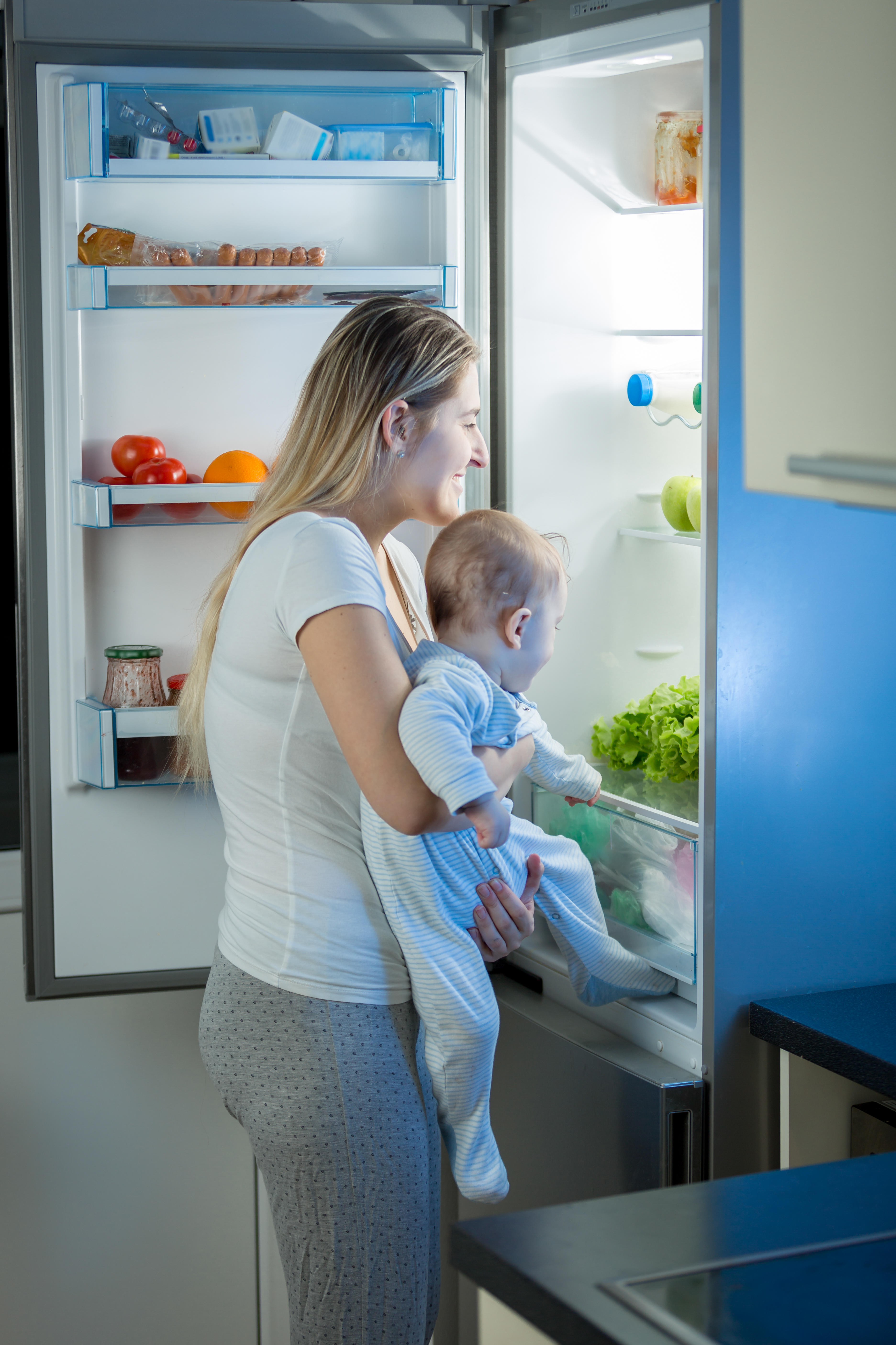 woman and baby looking in fridge