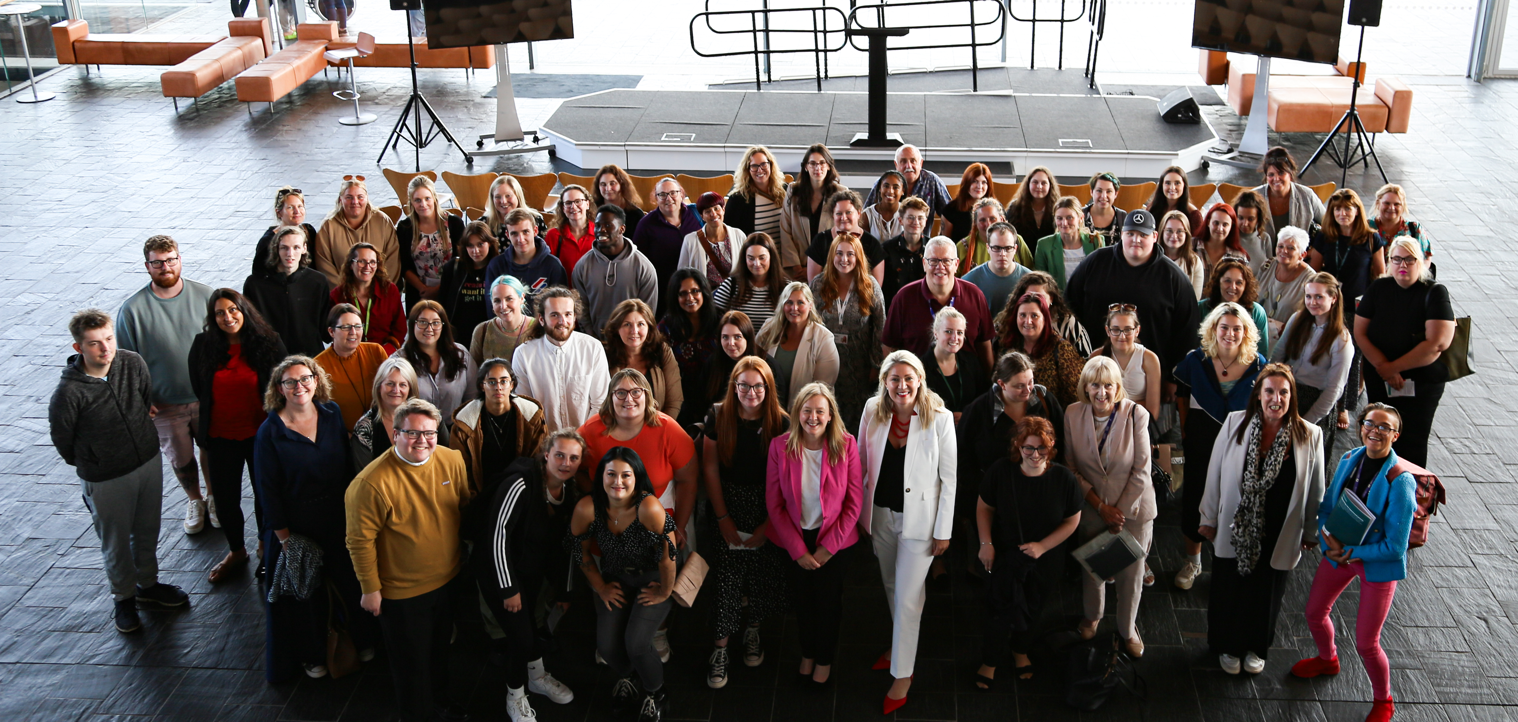 Group photo of care leavers, advocates, charity workers and academics who attended a joint debate at the Senedd on Wednesday night to discuss a radical overhaul of the care system. (Senedd)