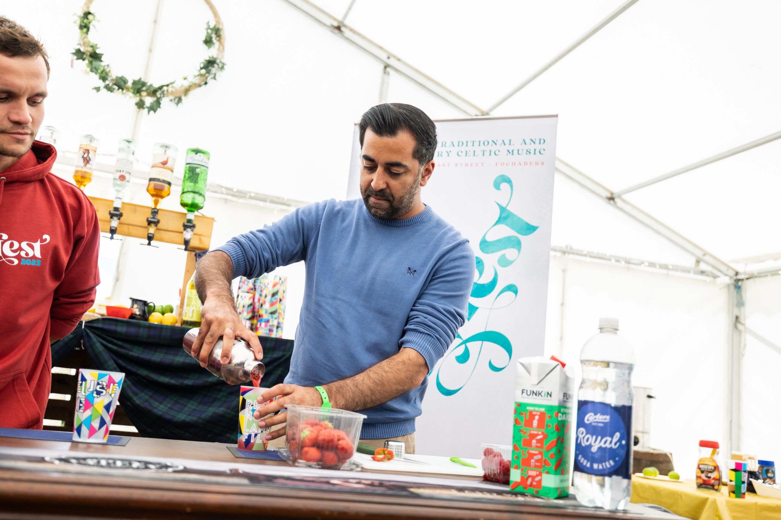 Humza pours a mocktail at the popular Speyfest in Moray.