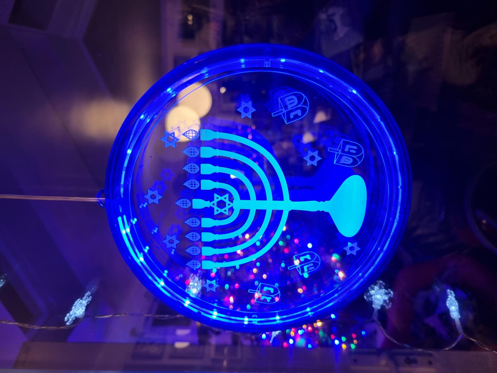 A symbol of the menorah with a Christmas tree in the backgroun