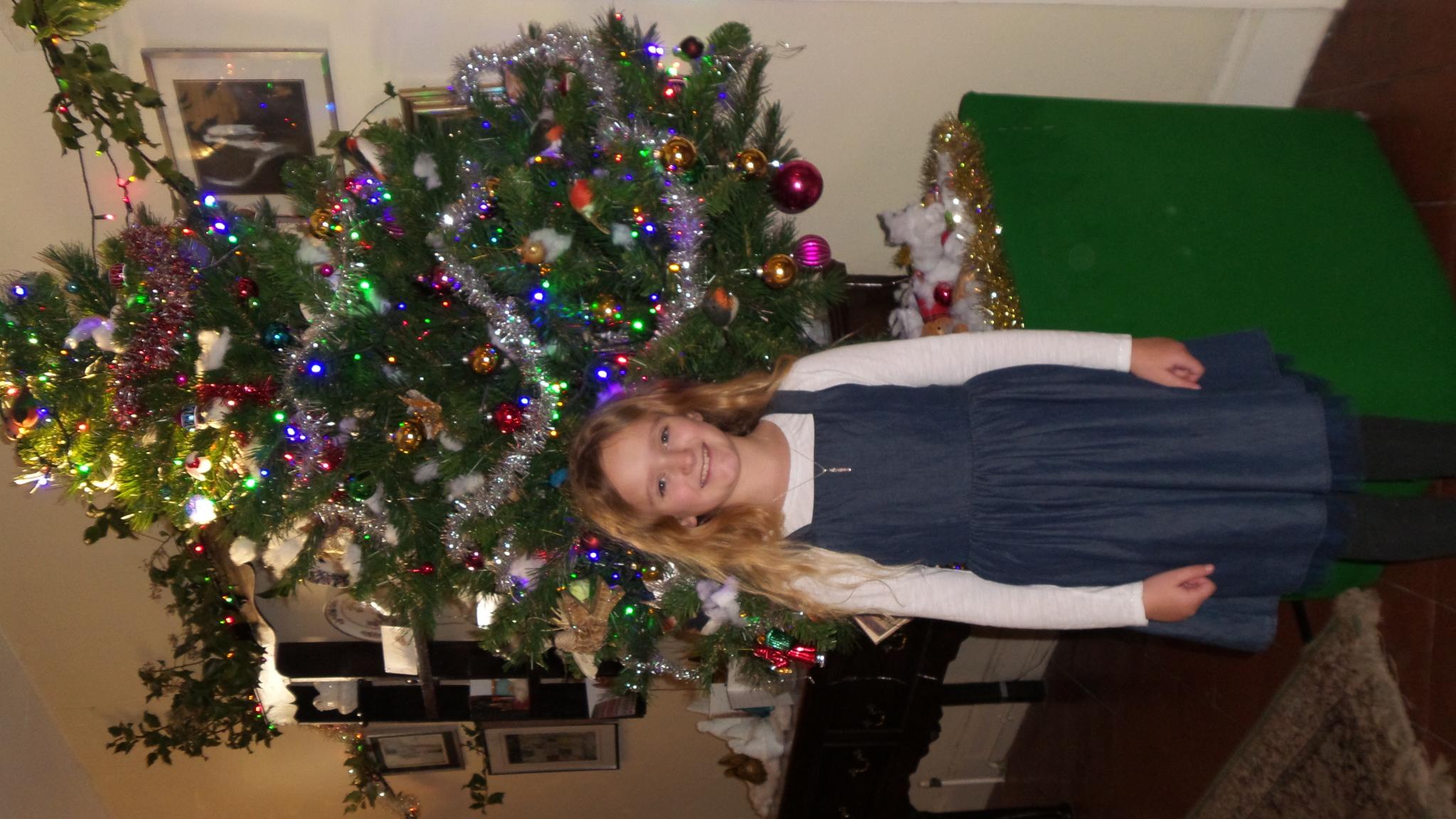 Bea Baldwin standing in front of a Christmas tree