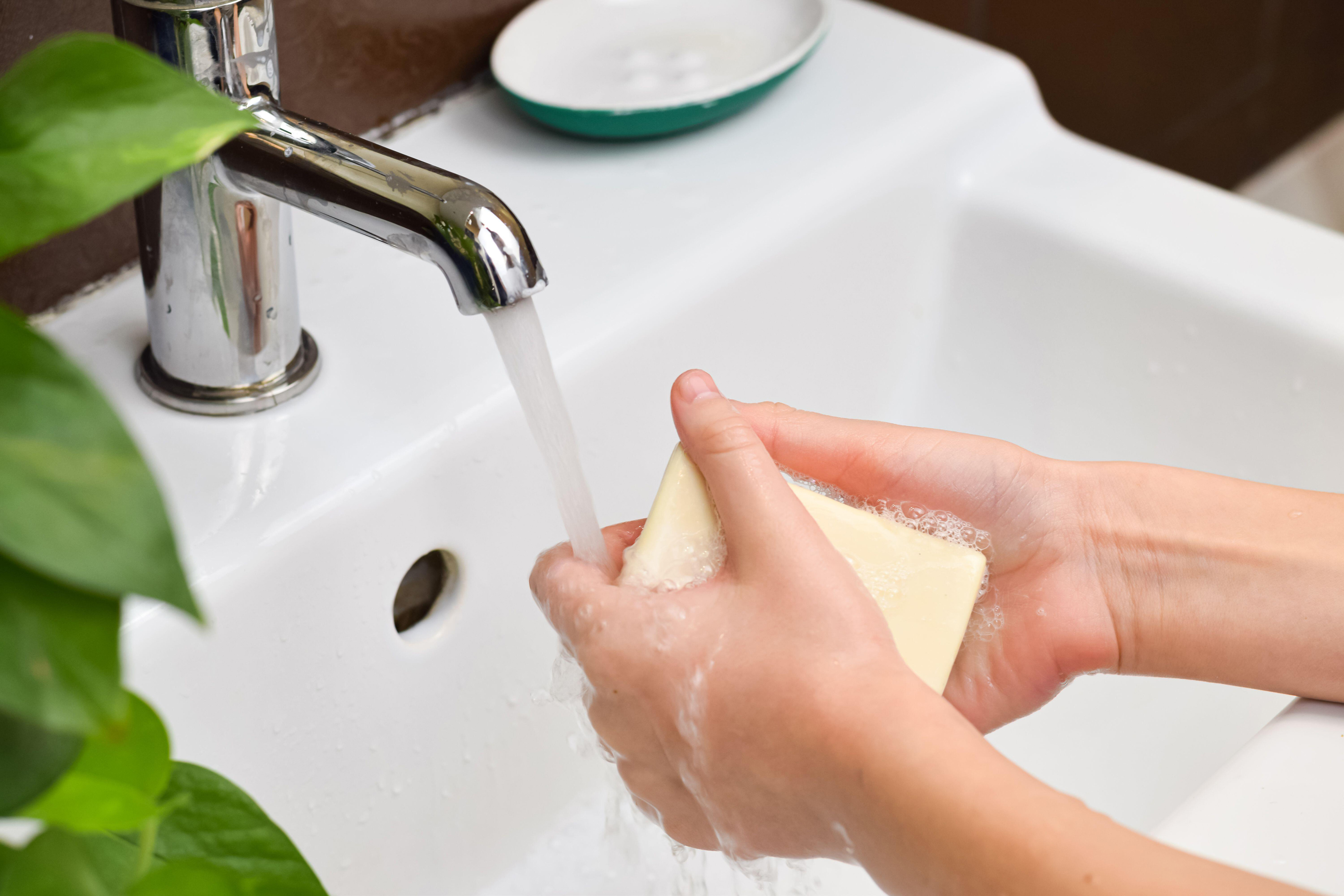 Child washing their hands against viruses and infections