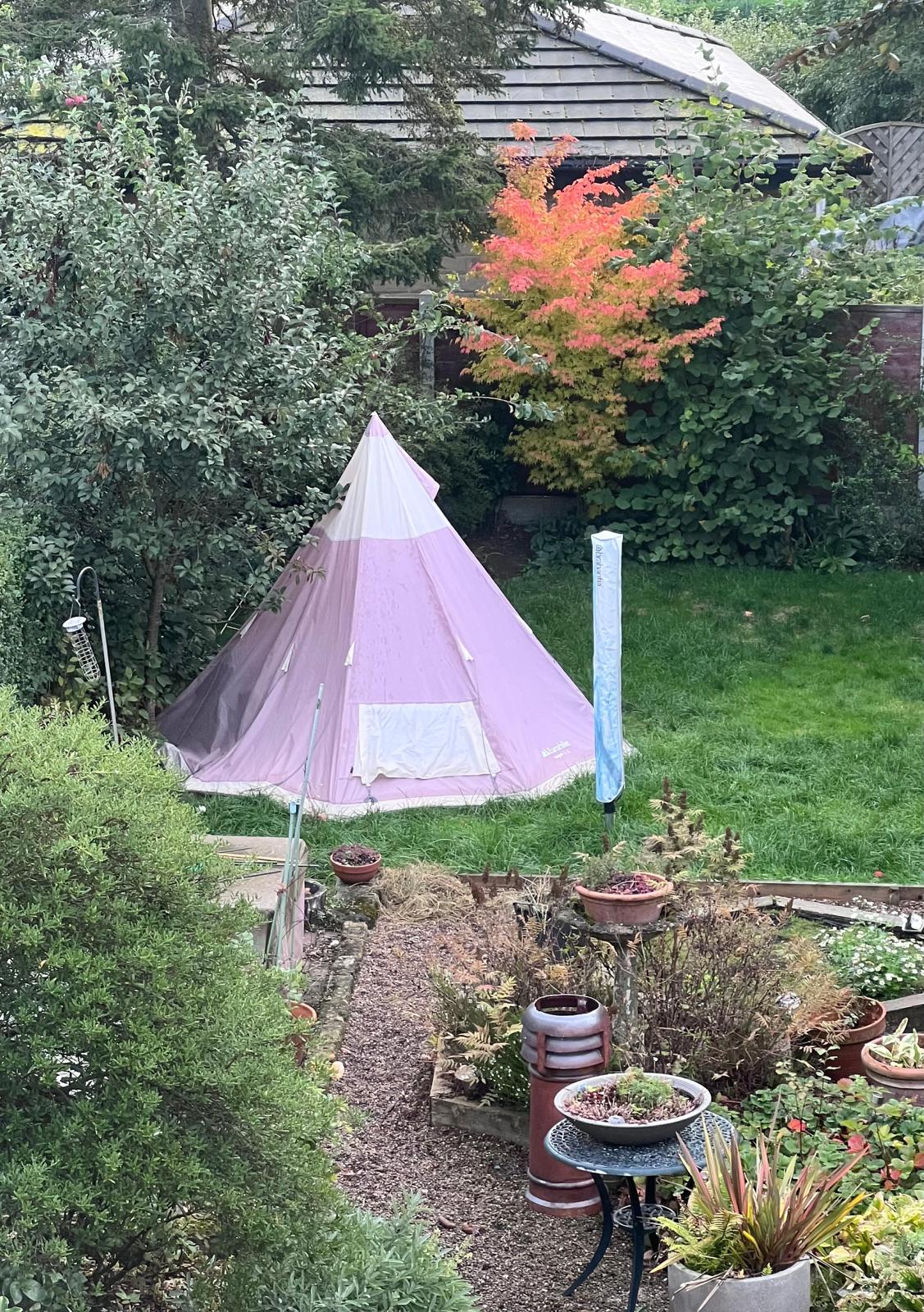 Billy's original teepee with pink fabric at the end of his garden