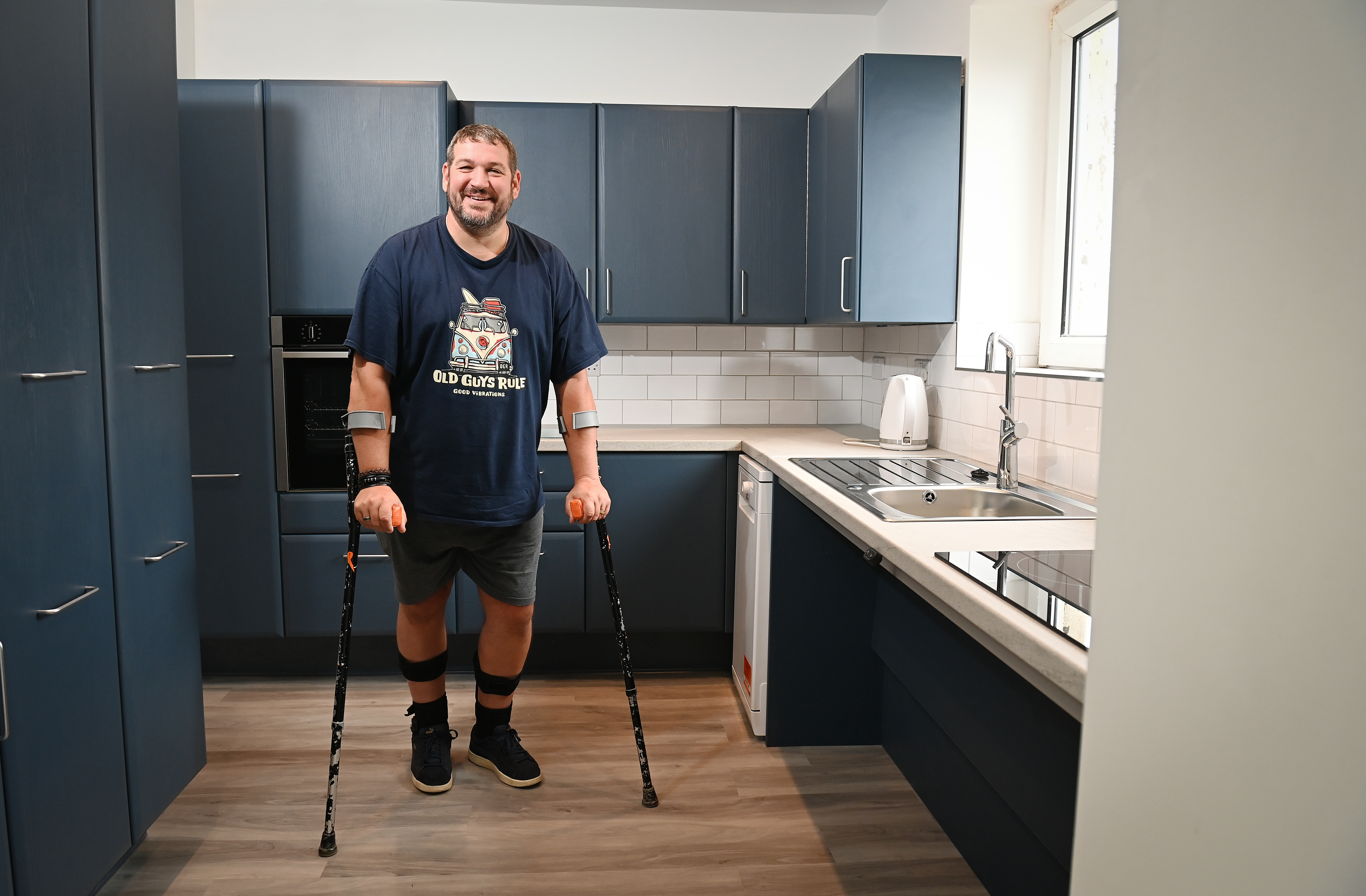 Chris Chappel in his new kitchen following the construction work (Matt Gilley/FPS Images/PA)