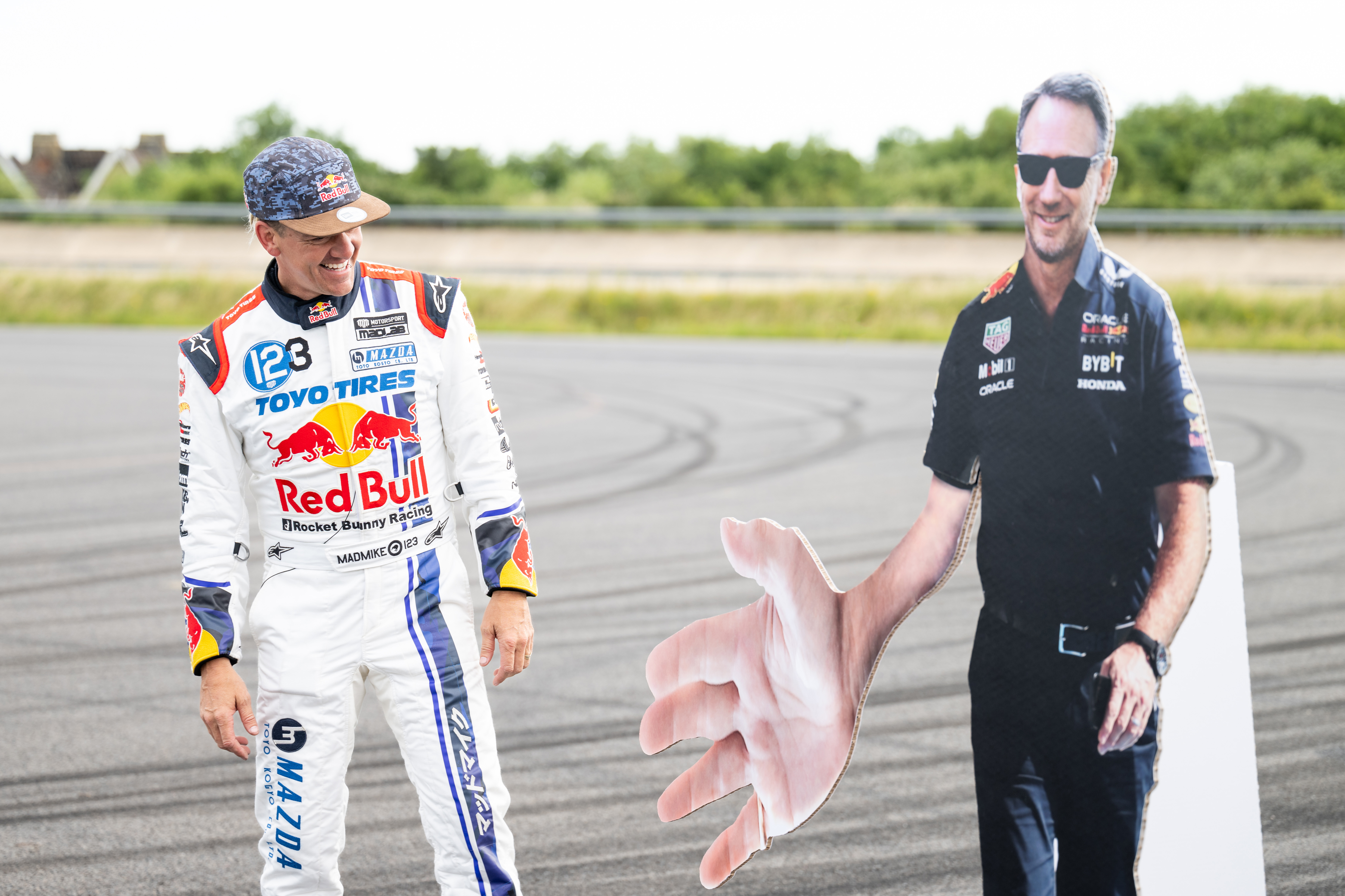 Mike Whiddett stood next to cardboard cutout of man with an oversized hand