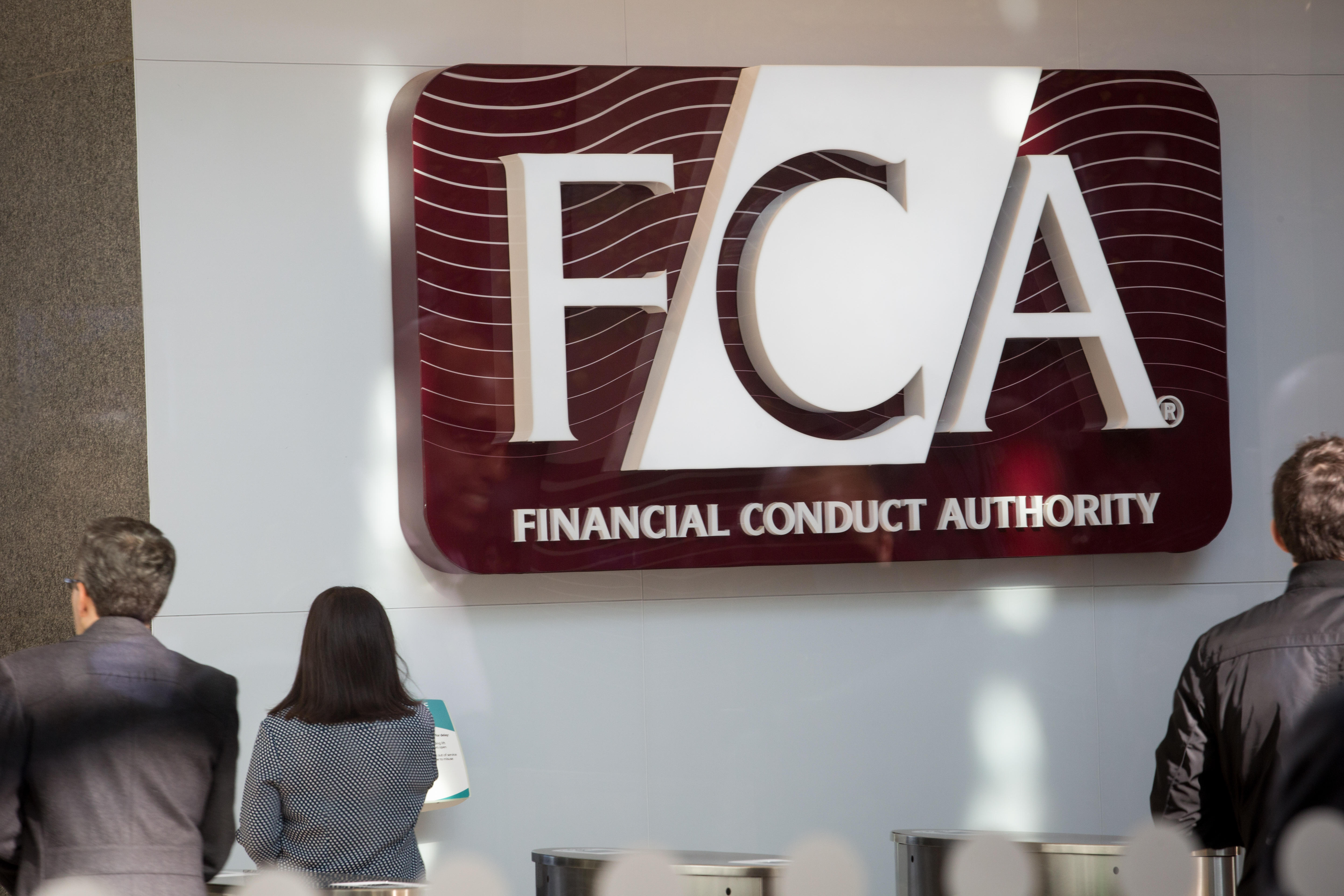 People standing in front of a large FCA sign