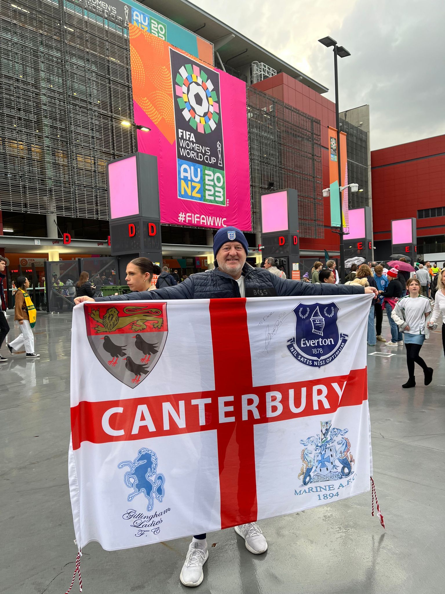 England fan outside Stadium Australia holding England flag