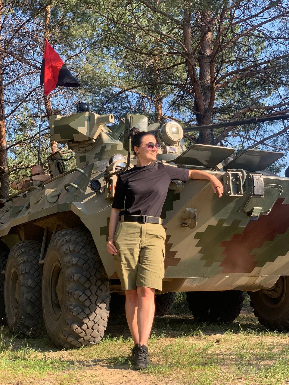 Woman posing in front of tank 