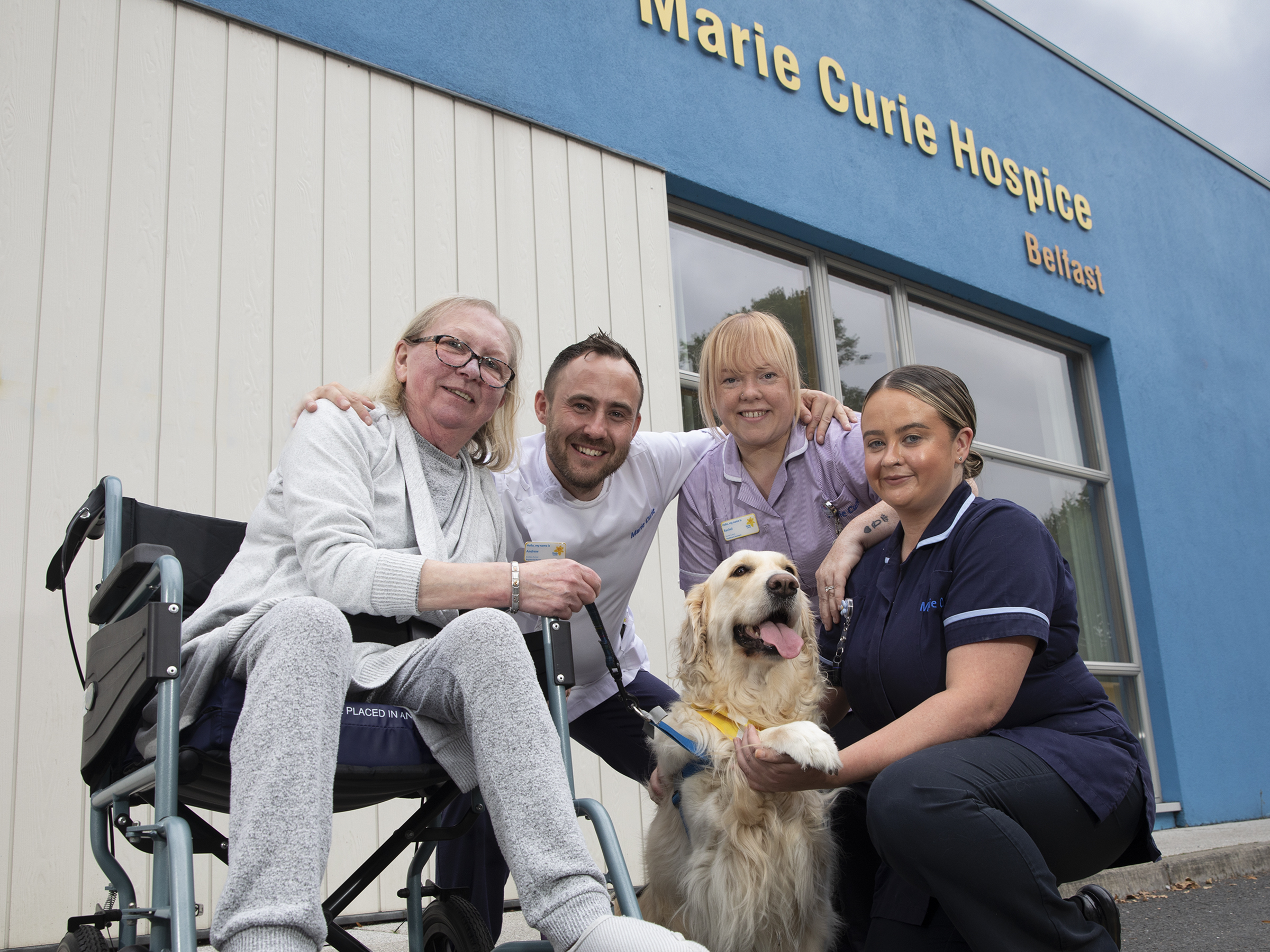 Patricia Hutchinson with, nurse Andrew Hunter, healthcare assistant Rachel McGlone and clinical nurse specialist Laura Cudden with volunteer therapy dog Sandi. (Phil Smyth/Marie Curie handout).