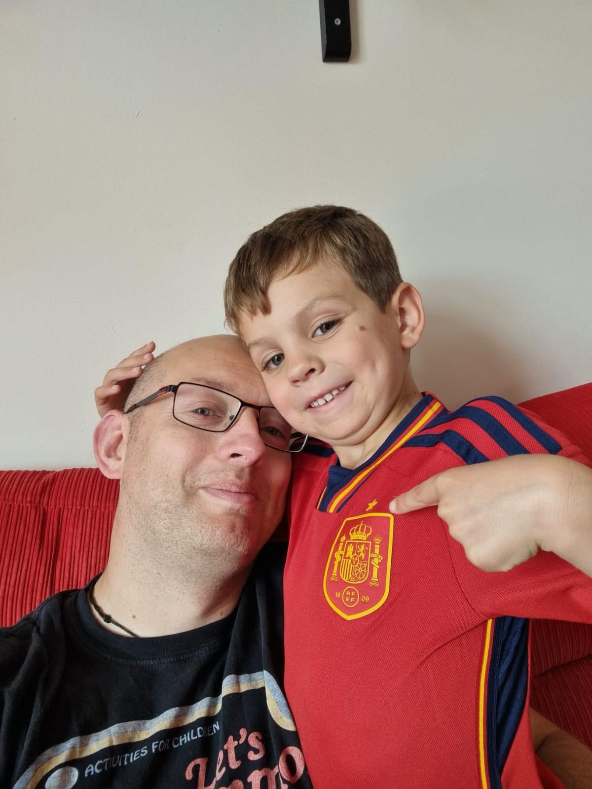 Father and son wearing Spanish football shirt