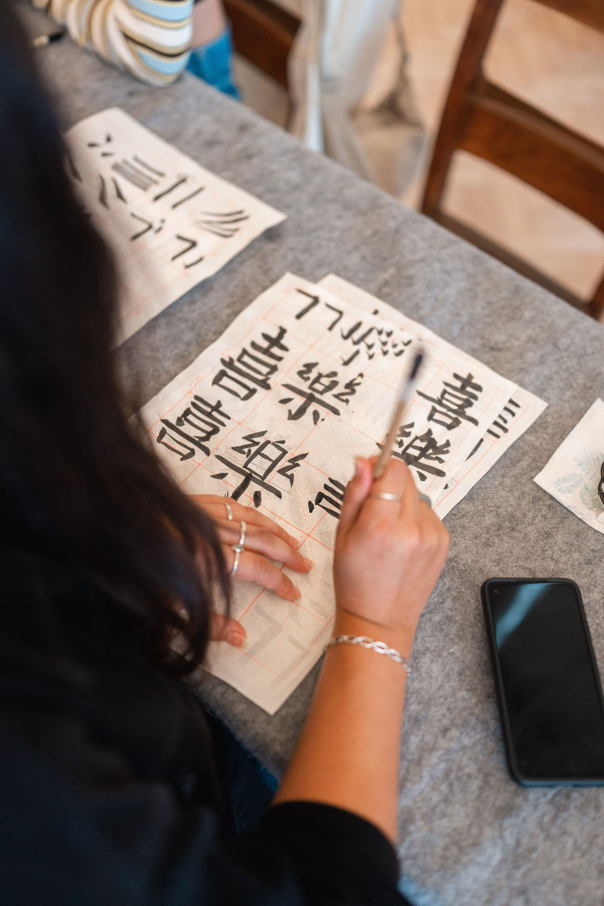 A woman using calligraphy to write Chinese characters