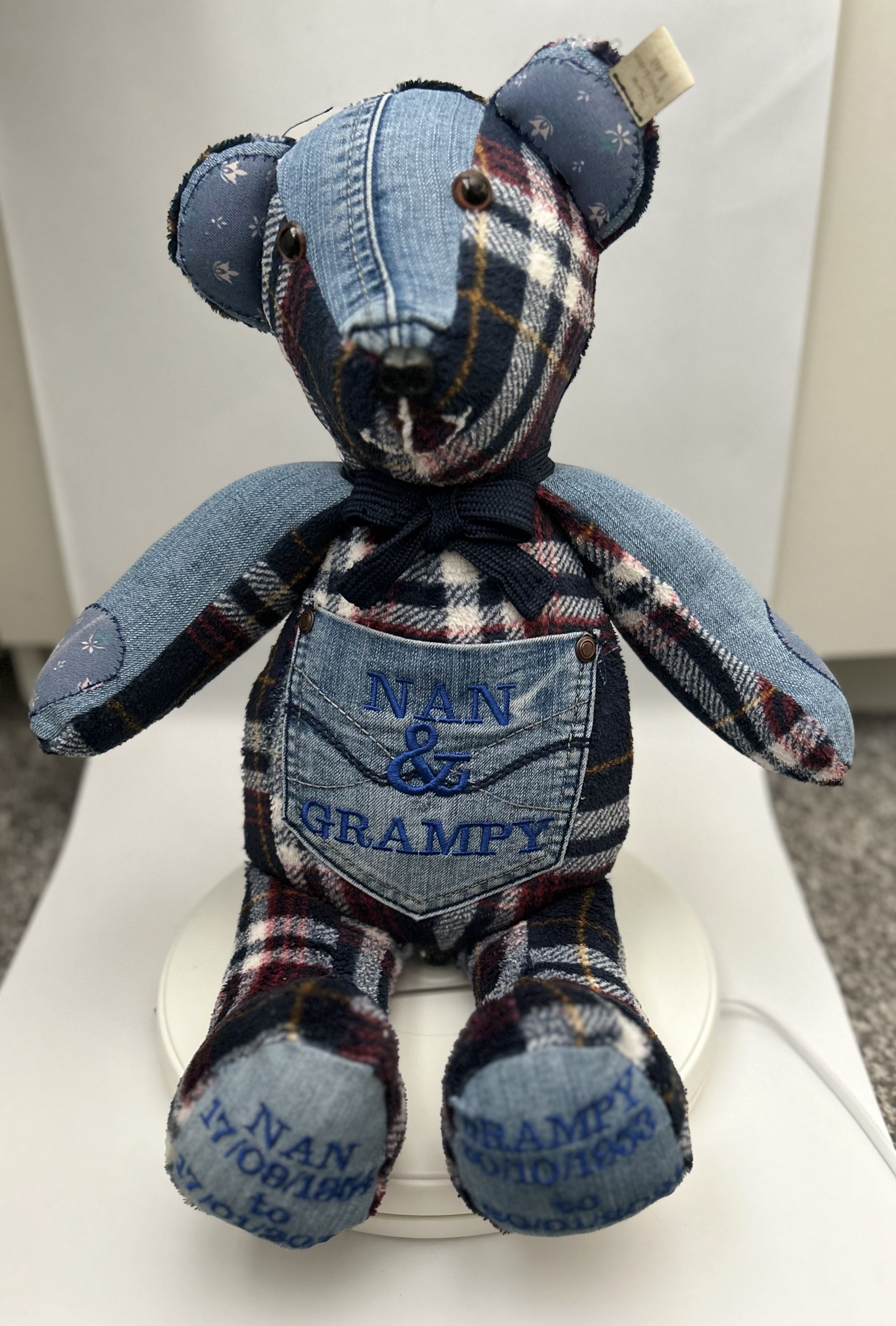 A patchwork bear reading 'Nan and Grampy' on the front