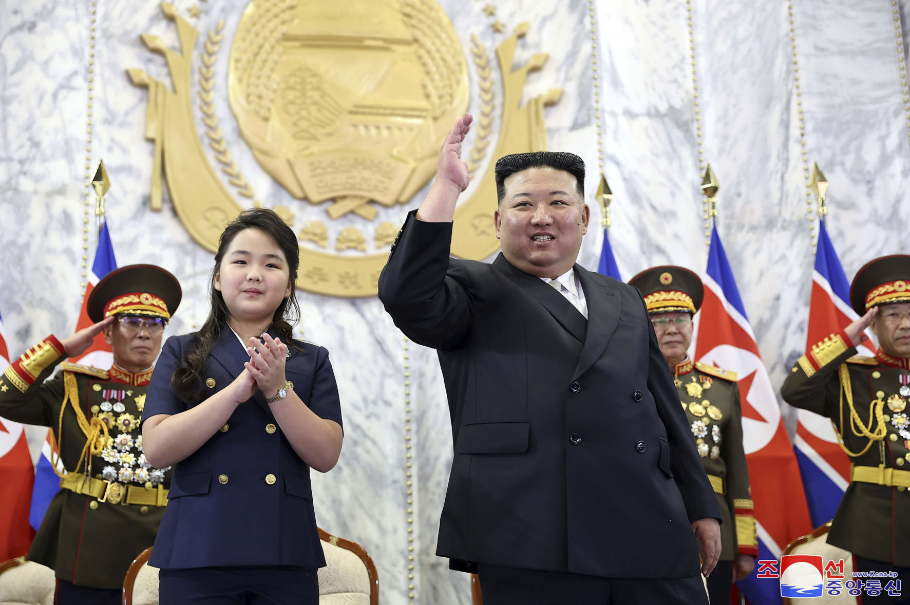 Leader Kim Jong Un (right) attends the parade with his daughter