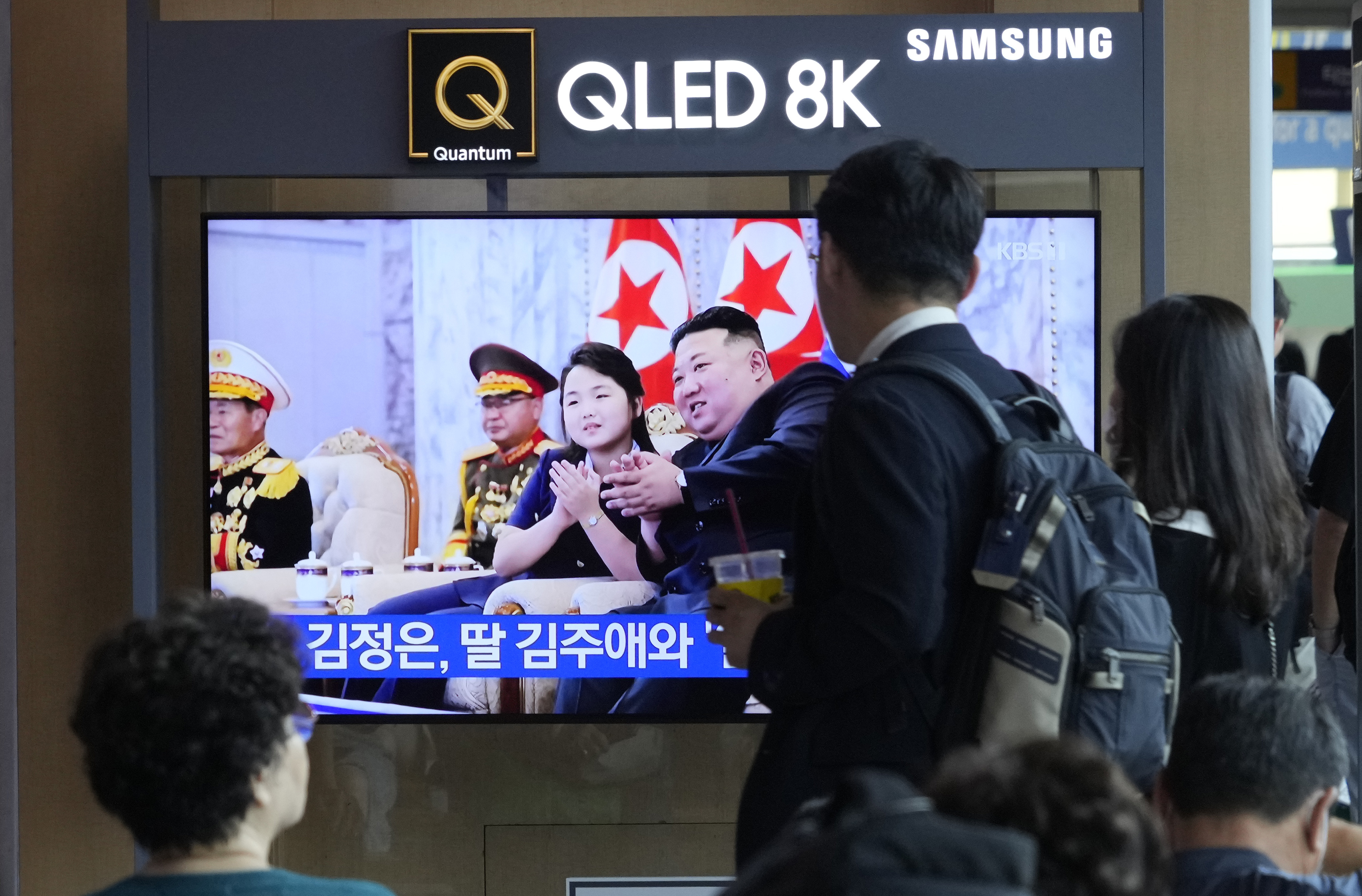 People at Seoul railway station in South Korea watch a TV screen 