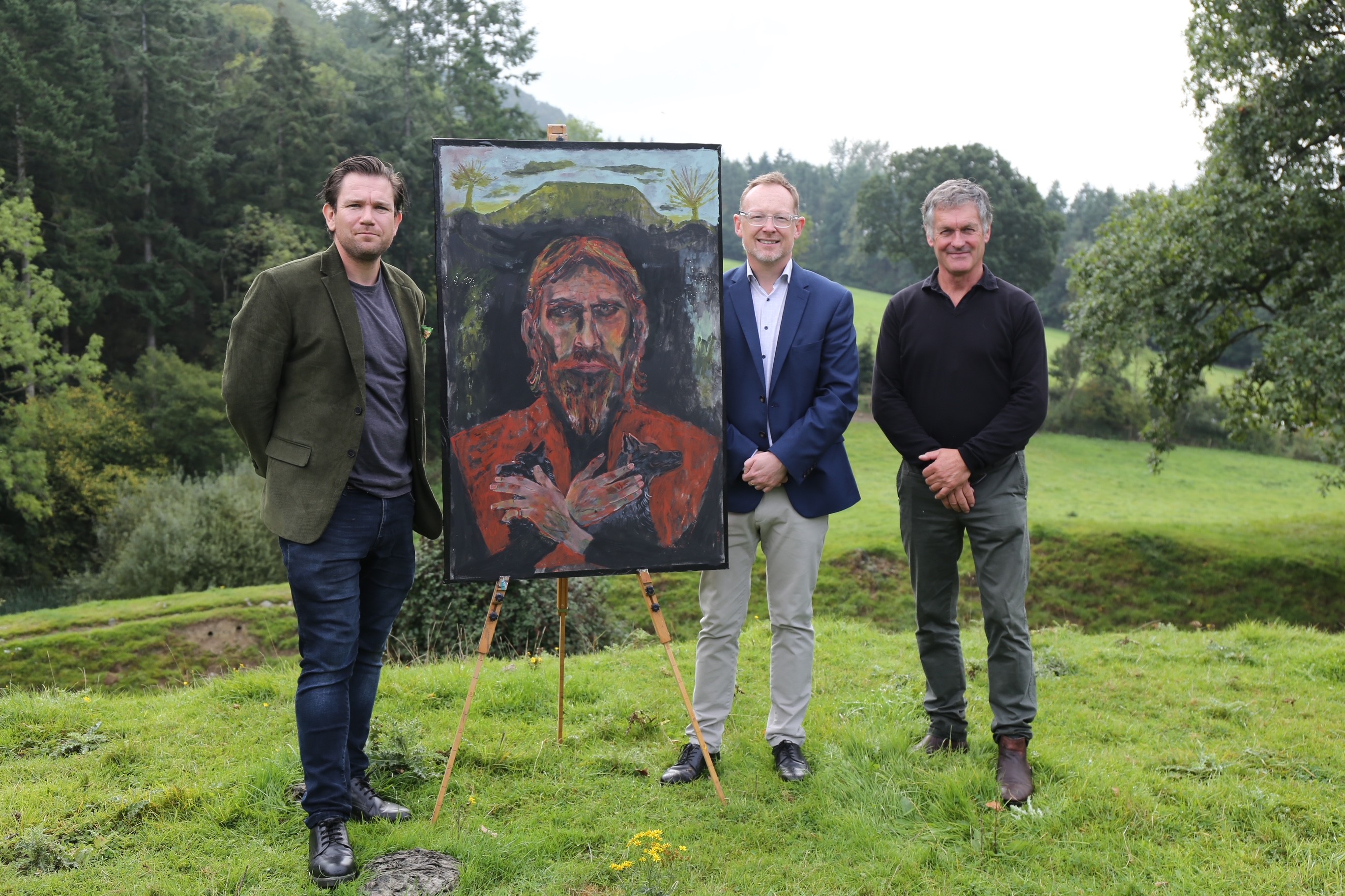 (from left) Artist Dan Llywelyn Hall, Montgomeryshire MS Russell George and Powys County Councillor Aled Davies at the unveiling of the painting of Owain Glyndwr at the site of Sycharth (Dan Llywelyn Hall/PA)