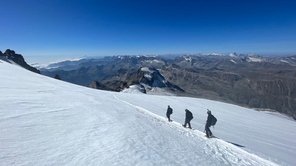 The trio walking through the snow on the mountain range