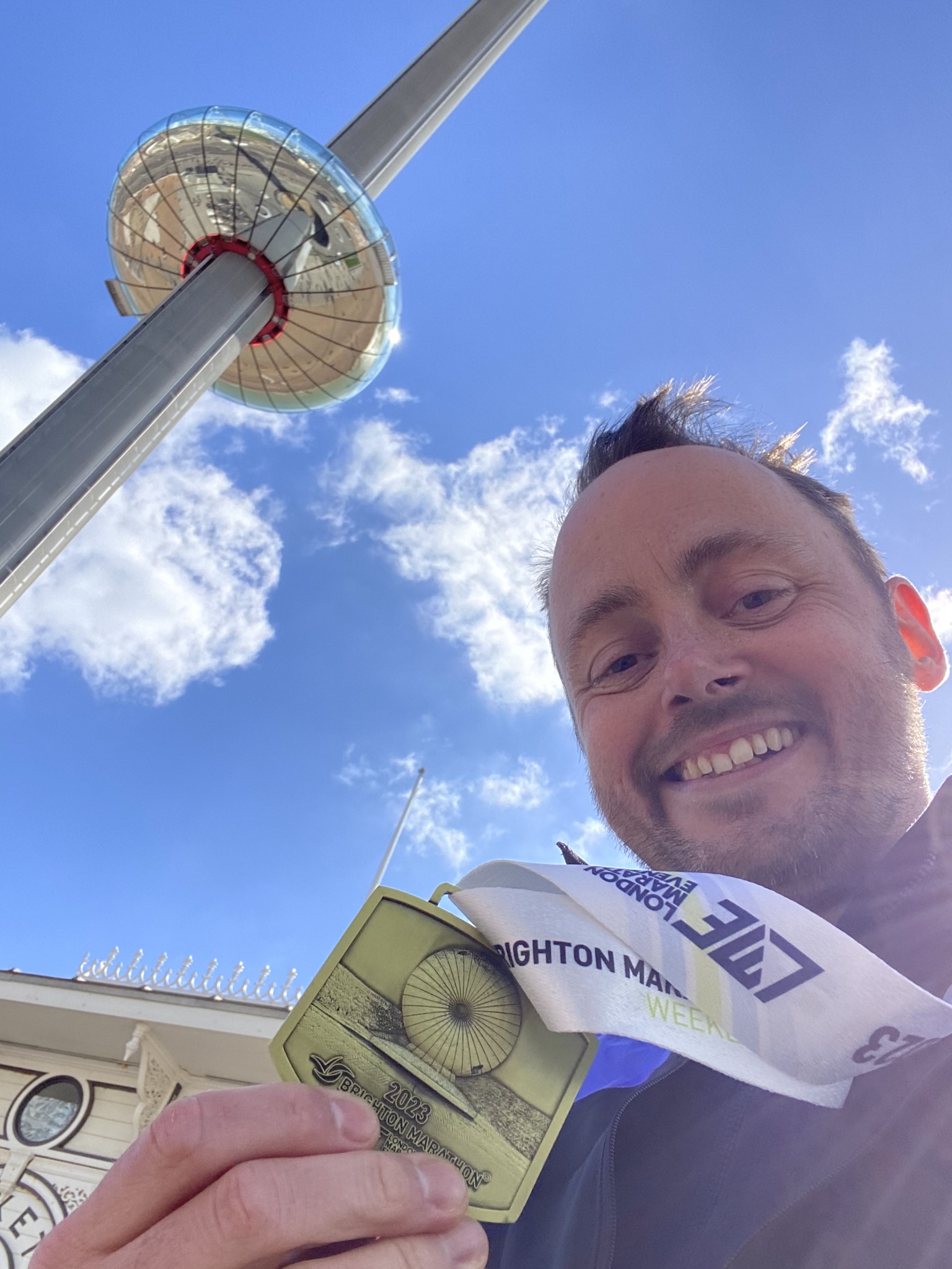 Man holding medal and looking at the camera 